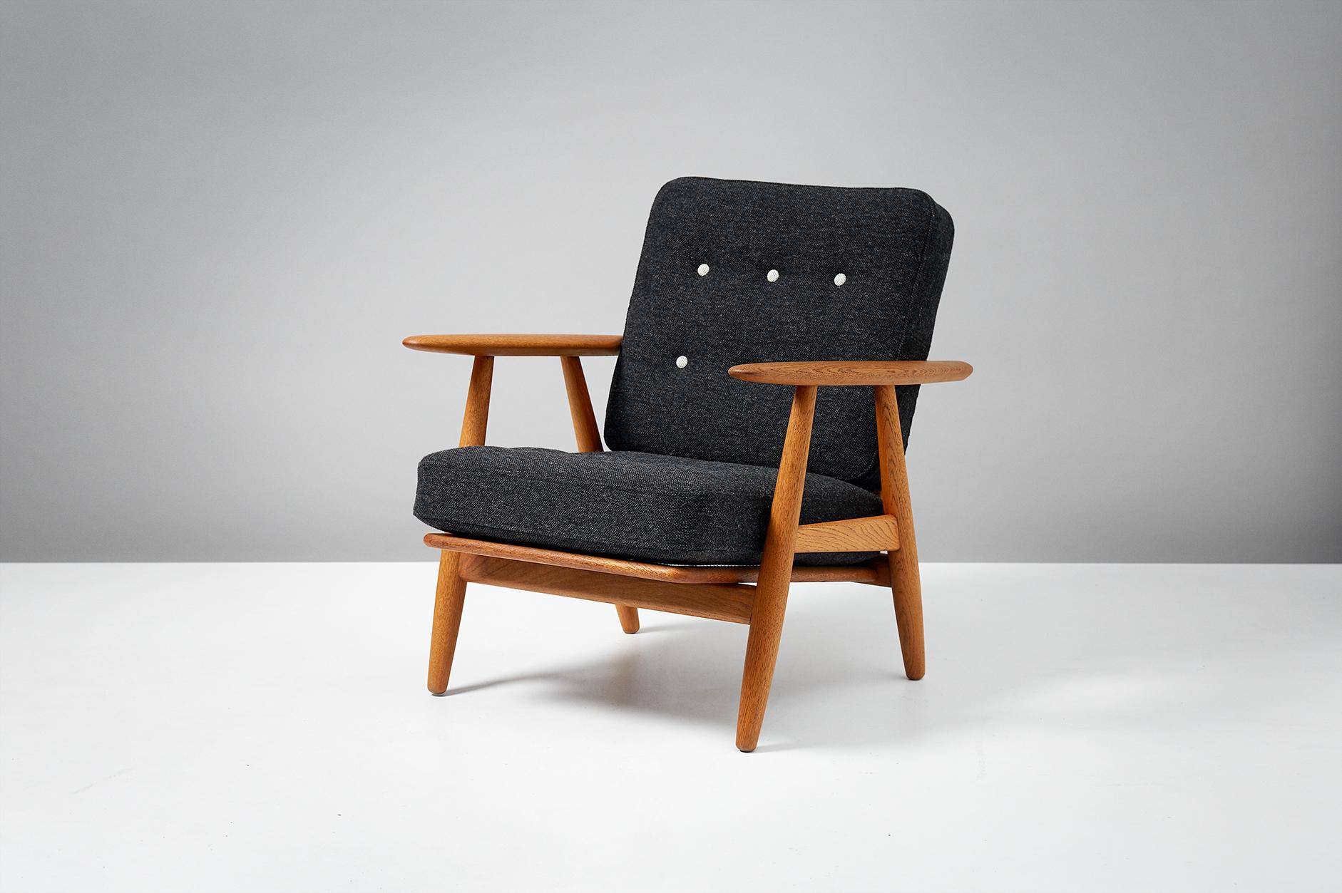 Hans J. Wegner

GE-240 'Cigar' Chair, 1955.

Produced by GETAMA, Gedsted, Denmark. Oak frame with original sprung cushions reupholstered in contrasting dark and light grey Kvadrat Hallingdal wool fabric. Maker's brand under seat.

