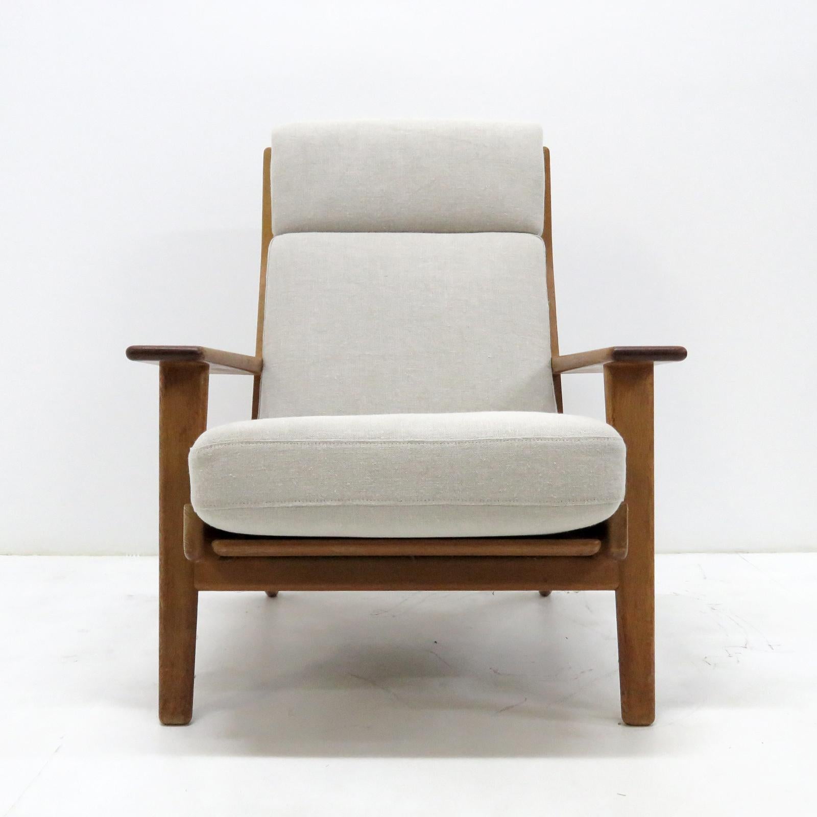 Wonderful high back lounge chair GE290 by Hans J Wegner for GETAMA, solid oak frame with nice patina and original cushions newly upholstered in Belgian linen fabric, marked.