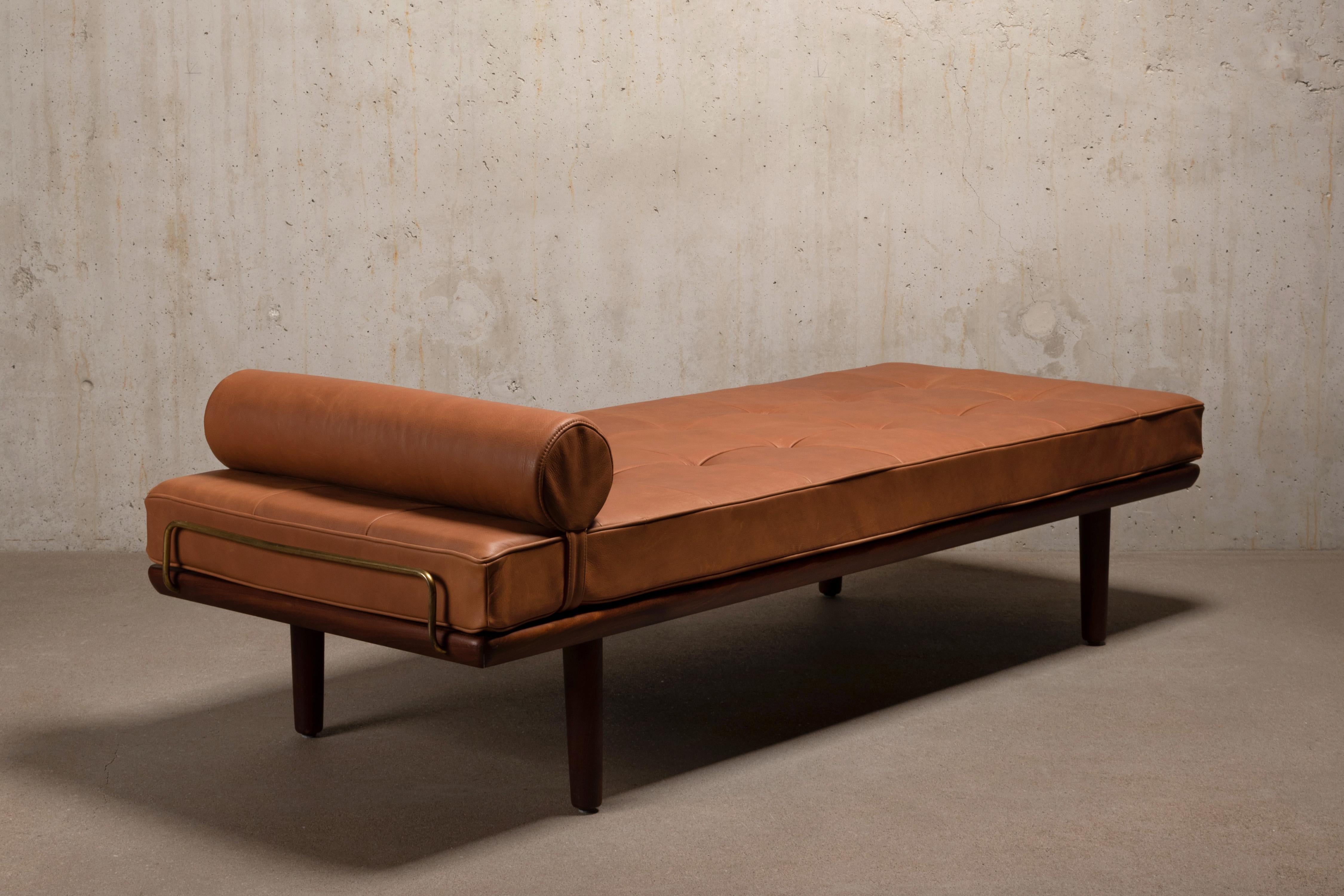 Great daybed Model GE19, designed by Hans Hans J. Wegner for GETAMA Denmark in 1956. Teak frame with tapered legs and brass brackets in good condition with minor traces of use. New mattress and neck roll pillow upholstered in beautiful high quality