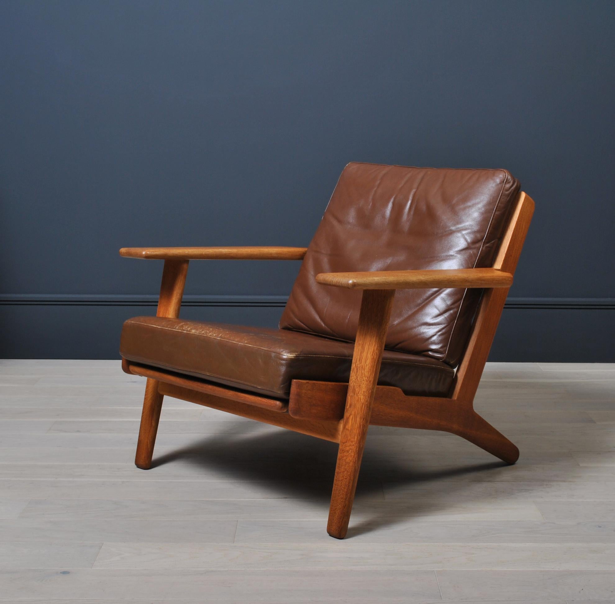 Original 1950s Hans J Wegner GE290 lounge chair in oak. Original soft brown leather - aged and patinated. Produced by GETAMA, Denmark. Other custom reupholstery is available in fabric or leather. Enquire for upholstery details and pricing. 
Original