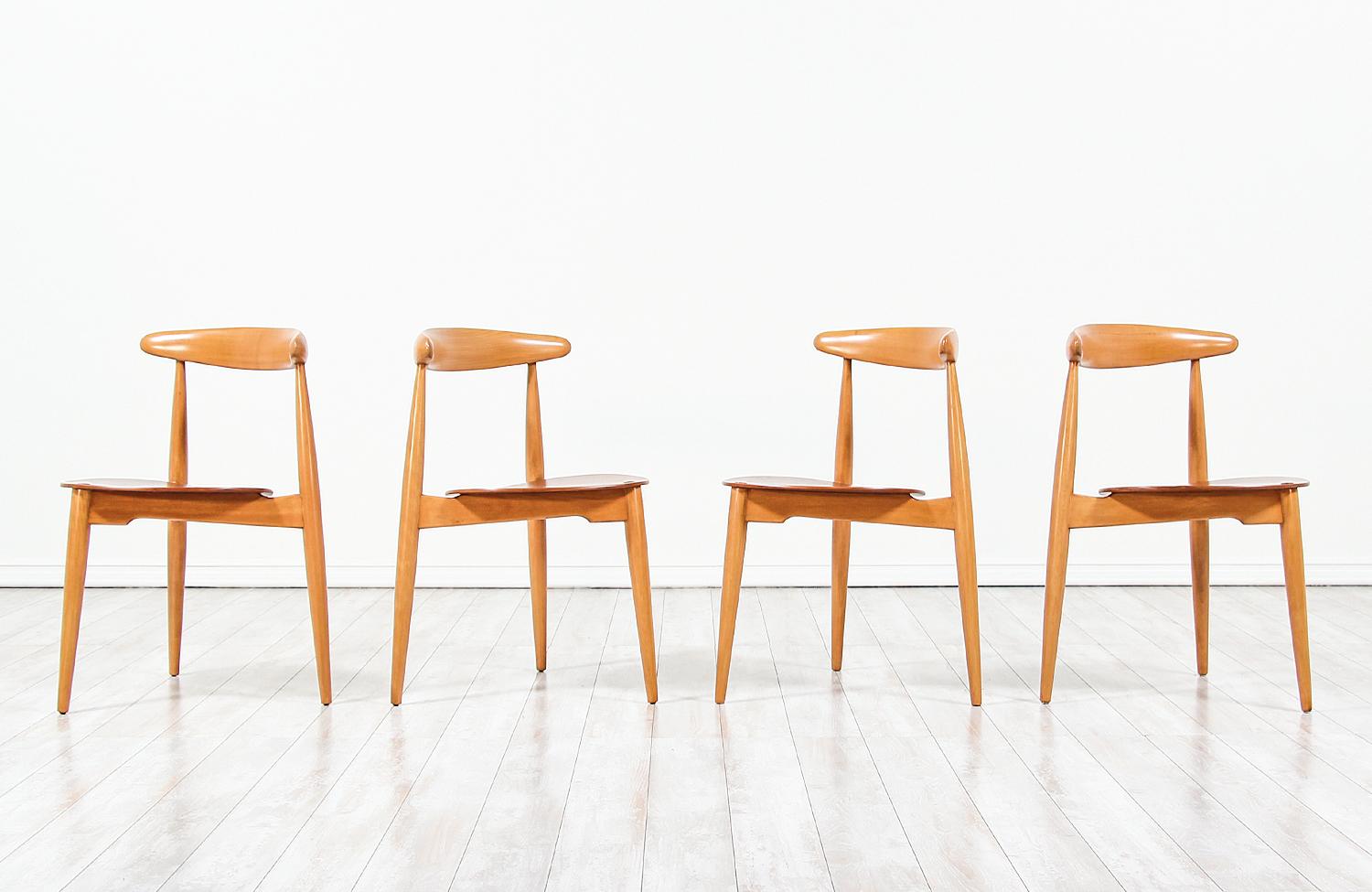 Set of four ‘Heart’ shaped dining chairs designed by Hans J. Wegner for Fritz Hansen in Denmark in 1952. Like many of Wegner’s designs, the model FH-4103 show a functional and thoughtfully mix of materials in construction demonstrating his excellent