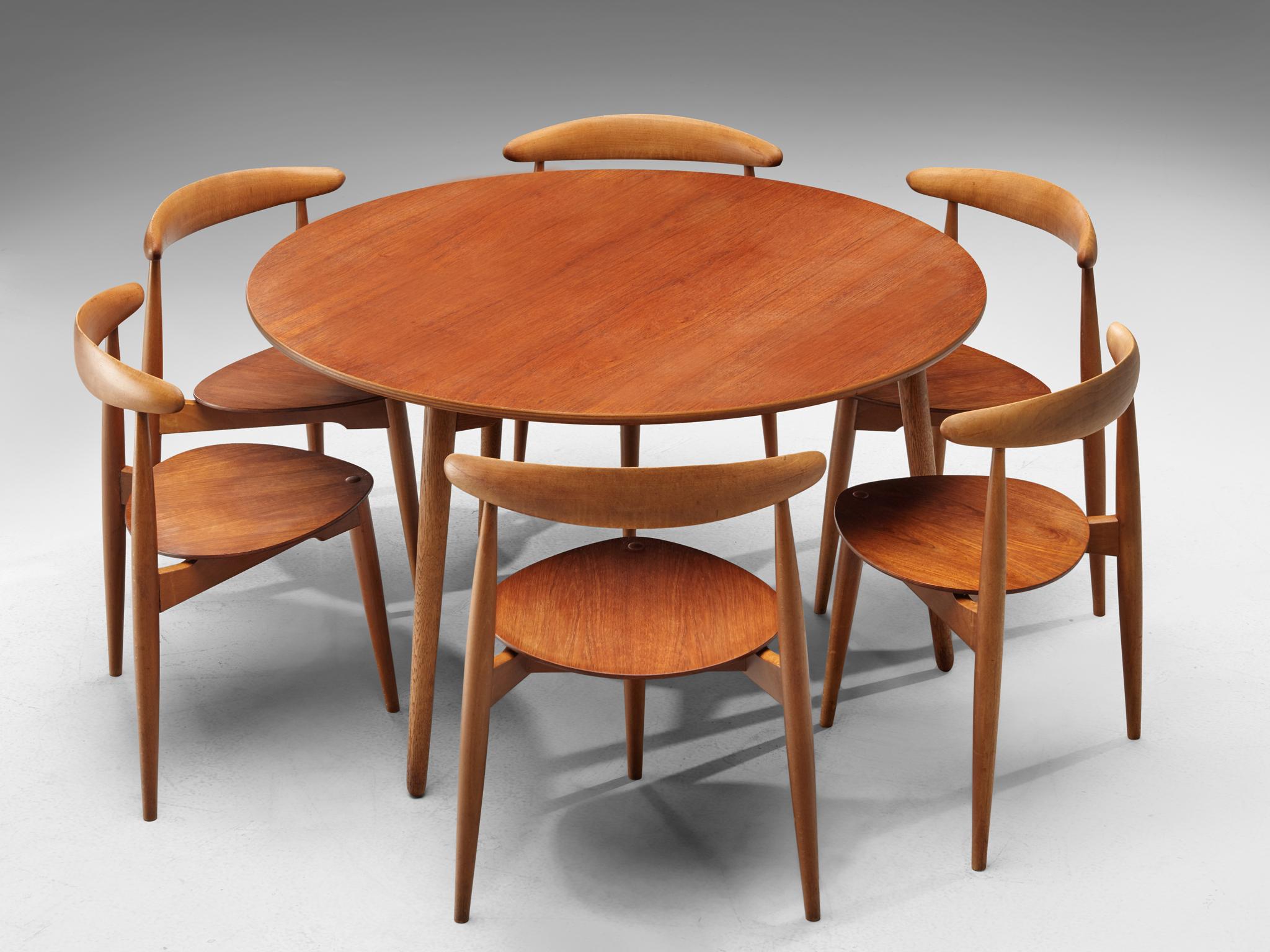 Hans Wegner, heart dining set with chairs and table, Denmark, beech and teak, 1953 (original design), 1960s execution.

Consisting of a tripod table and 