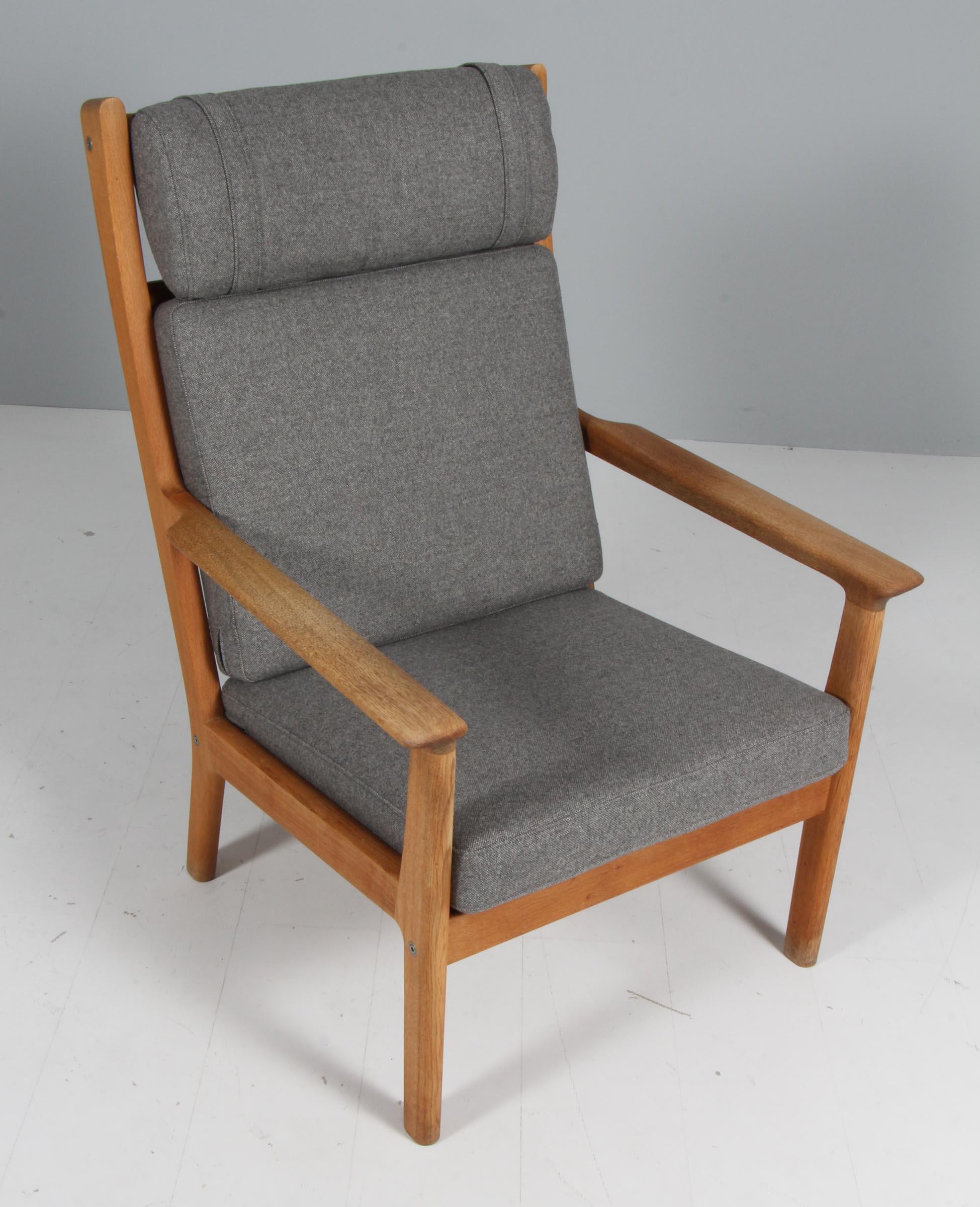 Hans J. Wegner highback lounge chair in solid oak. 

New upholstered with Magrethe wool from Nevotex.

Model GE265, made by Getama.