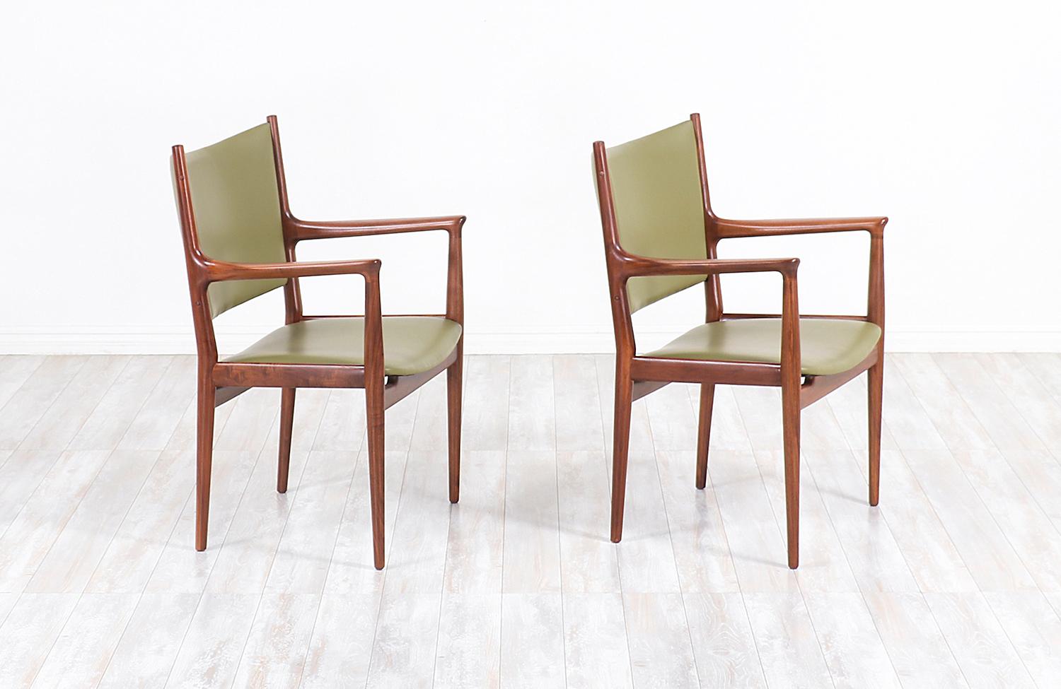 Pair of JH-509 armchairs designed by iconic Danish furniture designer Hans J. Wegner for Johannes Hansen in Denmark, circa 1950s. Initially designed for conference and meeting rooms, these ergonomic chairs showcase Wegner’s superior design ideals