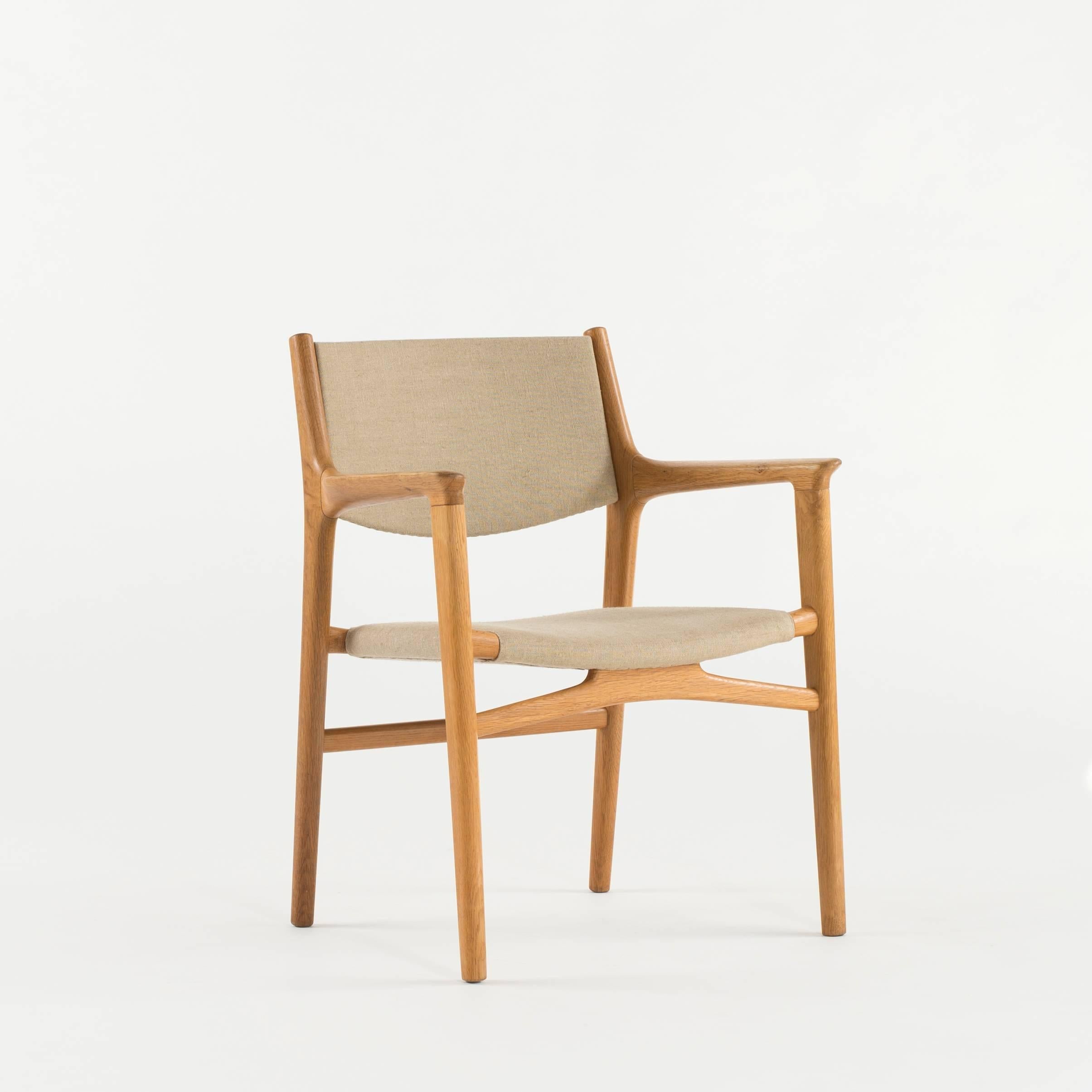 Hans J. Wegner model JH 515 oak armchair. Seat and back upholstered with canvas. Executed by cabinetmaker Johannes Hansen, Denmark.