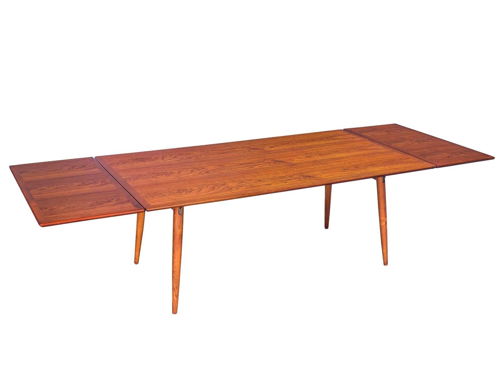 Hans J. Wegner JH570 dining table with expandable leaves for Johannes Hansen. This impressive, well preserved example has been cleaned and professionally refreshed with a hand-polished oil finish. As these images illustrate, the dining top surface