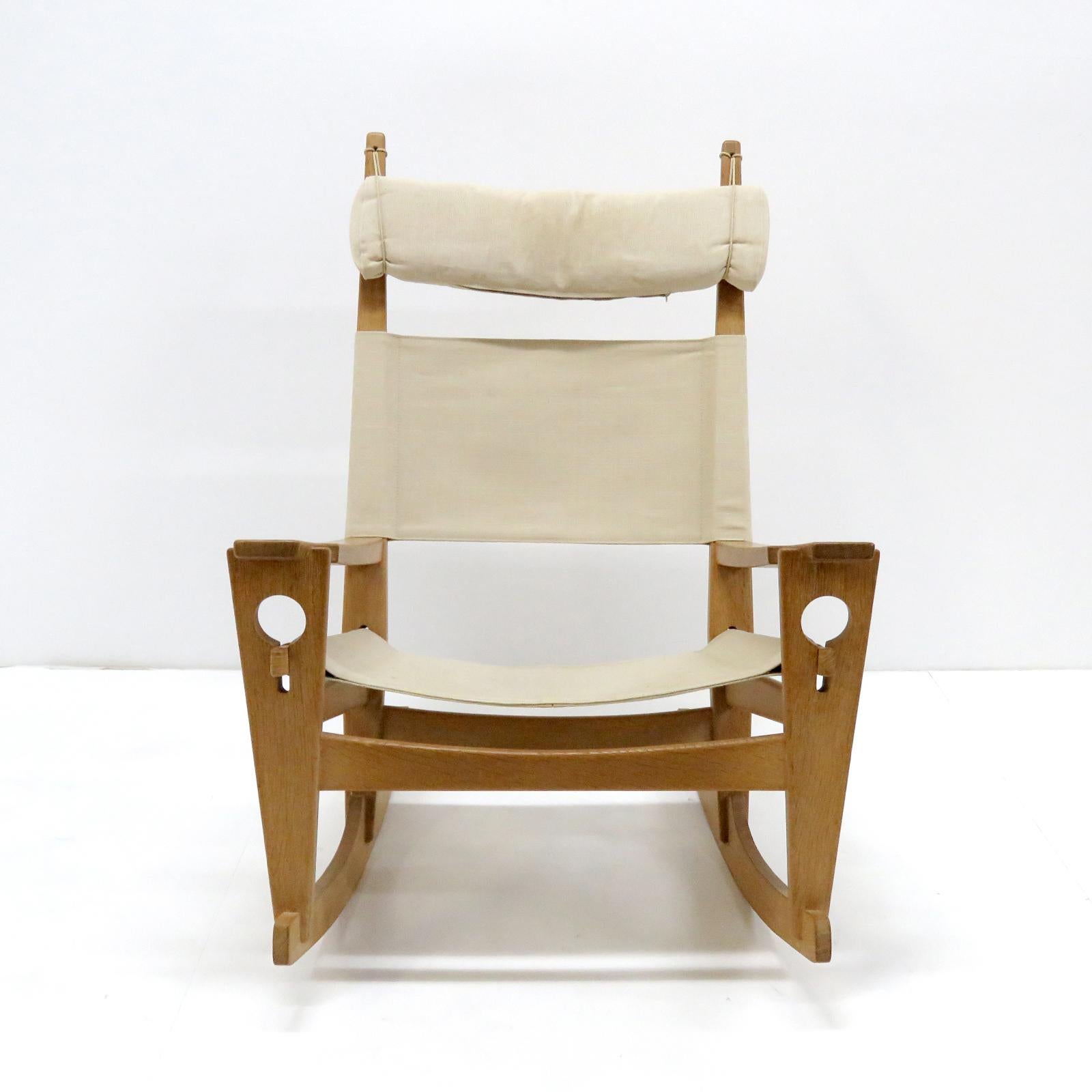Wonderful rocking chair 'Keyhole' model GE-673, by Hans Wegner for GETAMA, designed in 1967, oak frame with natural linen of later date and original head rest, all wood joints without metal hardware featuring the unique keyhole-shaped joinery that