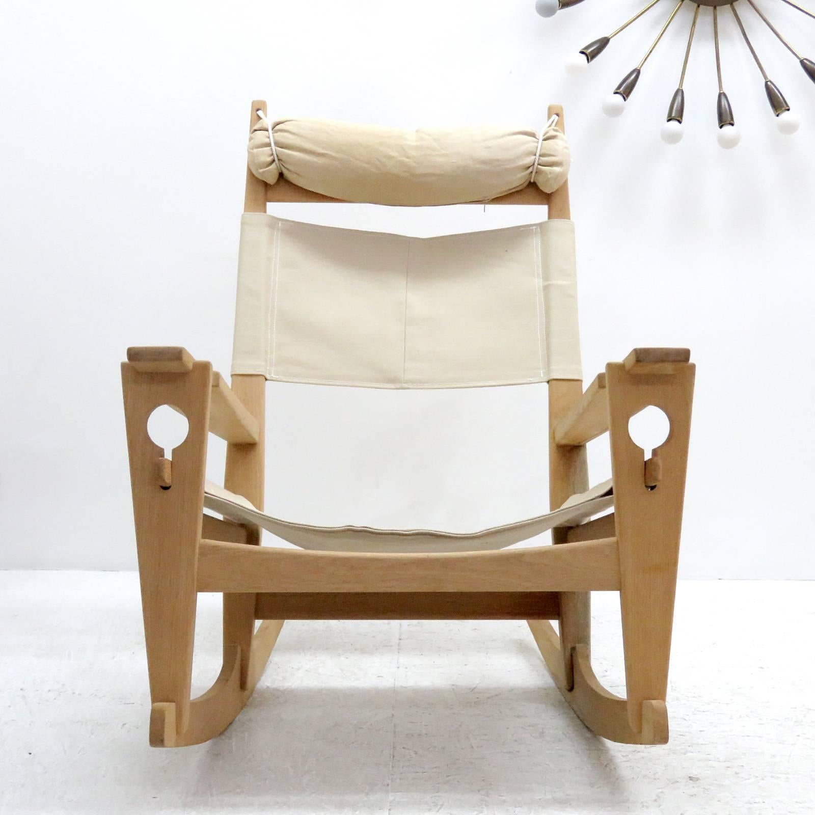 Wonderful rocking chair 'Keyhole' model GE-673, by Hans Wegner for GETAMA, designed in 1967, oak frame with natural linen of later date and original head rest, all wood joints without metal hardware featuring the unique keyhole-shaped joinery that