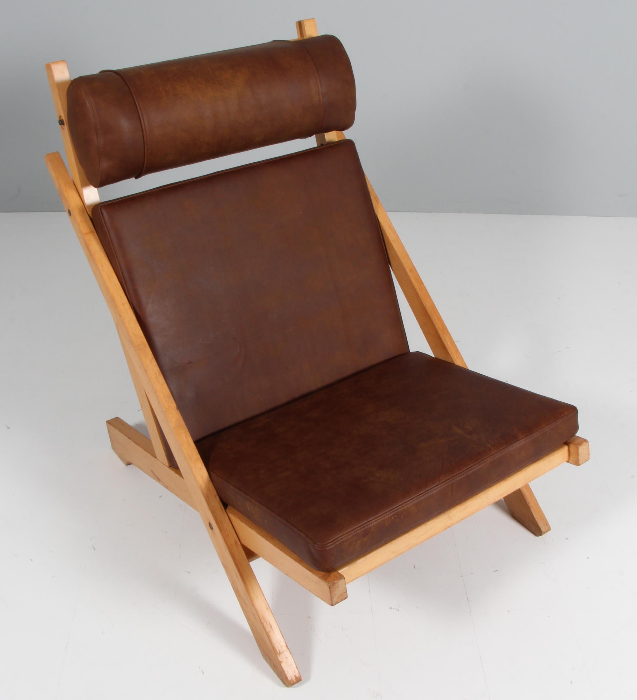 Hans J. Wegner Lounge chair with frame of solid  beech. With boat cord in the seat. 

New upholstered with with aniline leather details.

Model CH3, made by Carl Hansen. Rarely seen model.