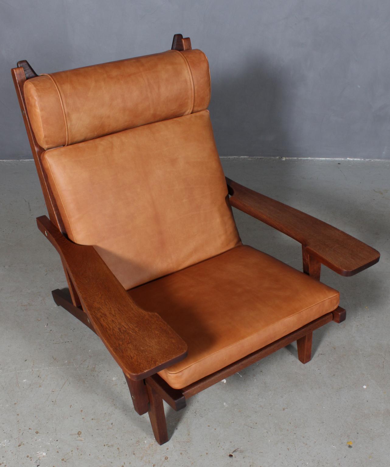 Hans J. Wegner lounge chair with loose cushions new upholstered with tan aniline leather.

Frame of smoked oak. With armrests.

Model GE-375, made by GETAMA.