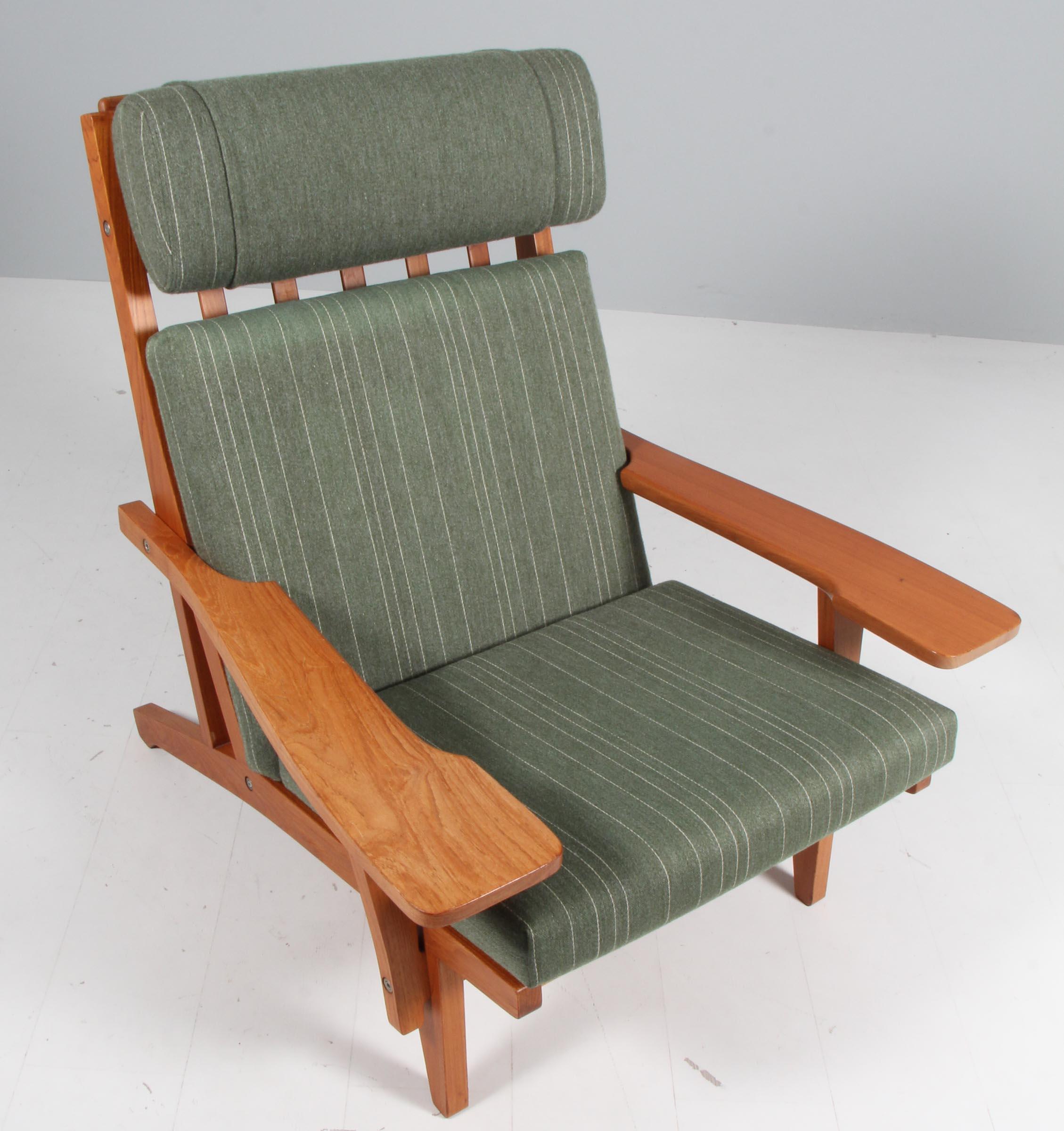Hans J. Wegner lounge chair with loose cushions upholstered with green savan wool.

Frame of teak. With armrests.

Model GE-375, made by GETAMA.