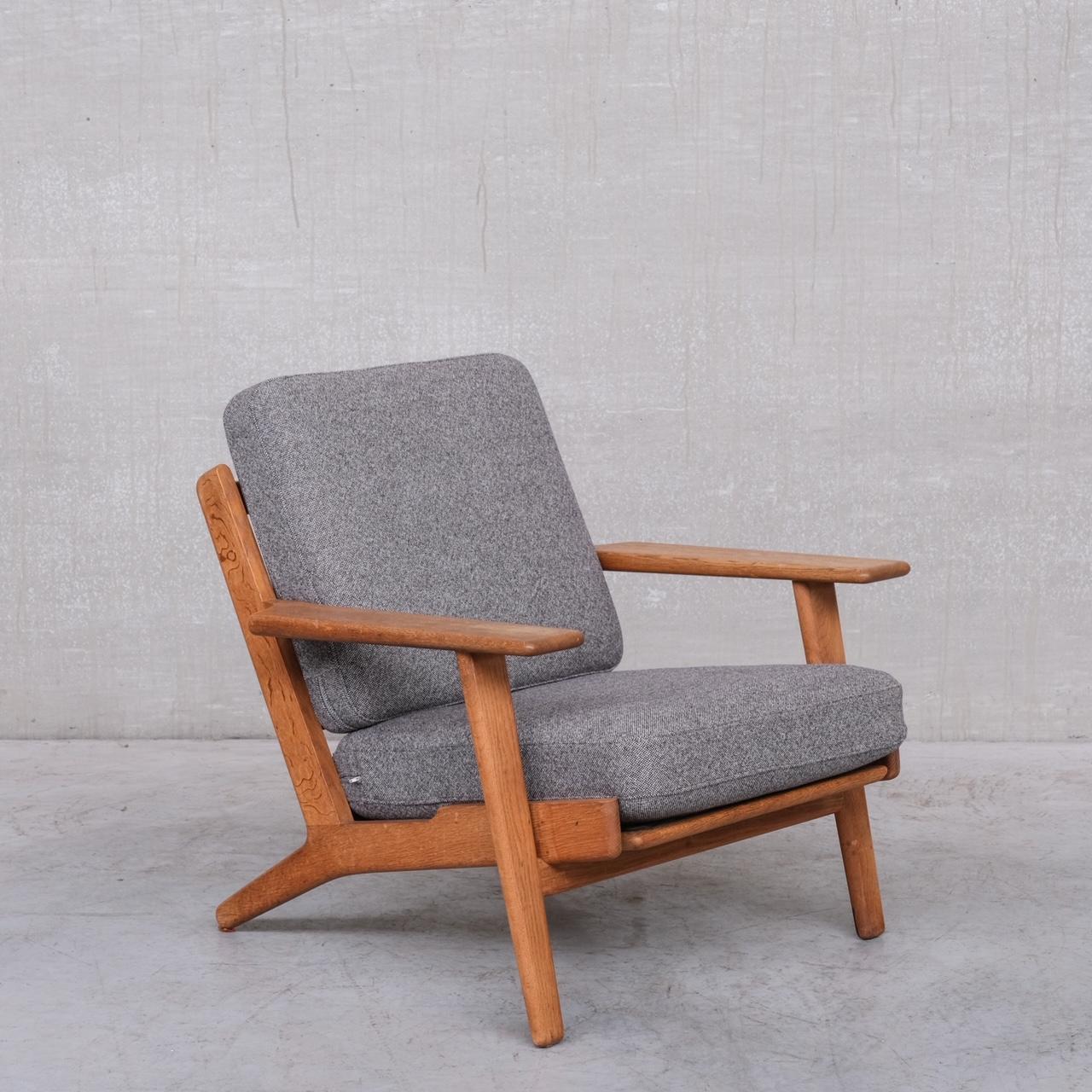 An increasingly hard to find lounge chair by legendary designer Hans J Wegner. 

Denmark, c1960s. 

Solid oak. GE-290 Model. 

Stamped to underside. 

Re-covered in fresh upholstery fabric. Totally ready to go. 

Location: Belgium