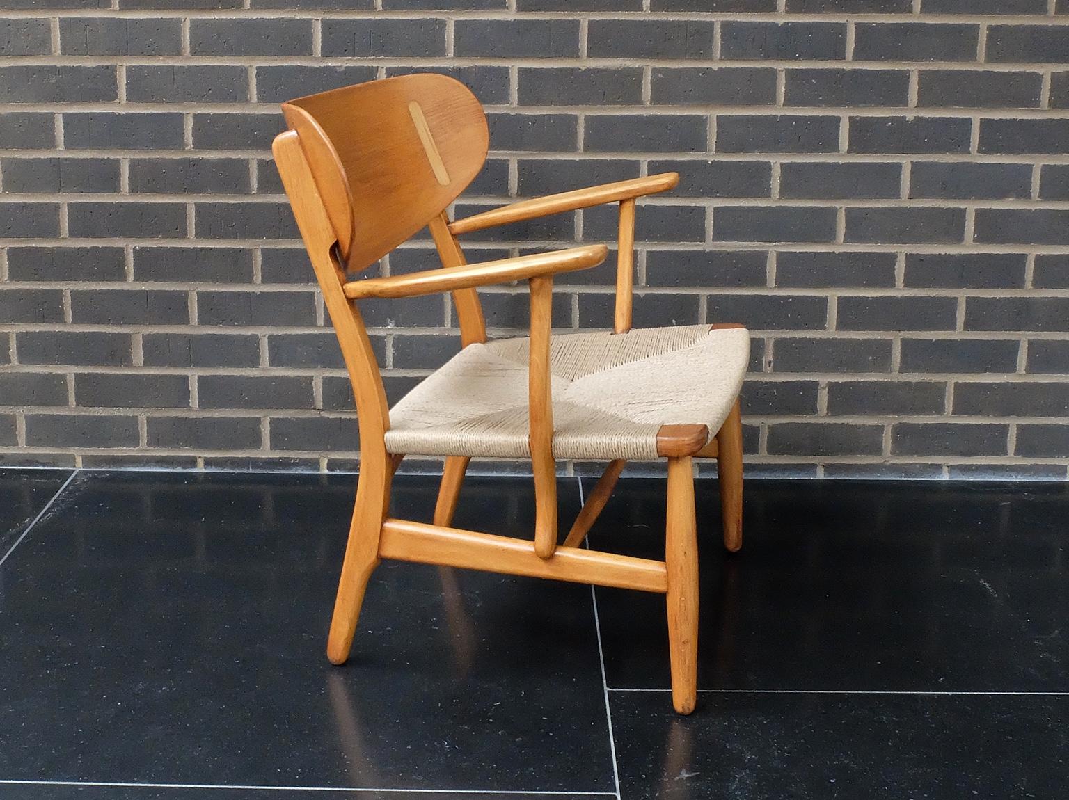 Hans J Wegner designed the CH22 armchair for Carl Hansen and Son in 1950 and it is the rarest and most sought after of the original four designs produced at that time. This chair is very unusual in that it was made in the 1950's and is one of three