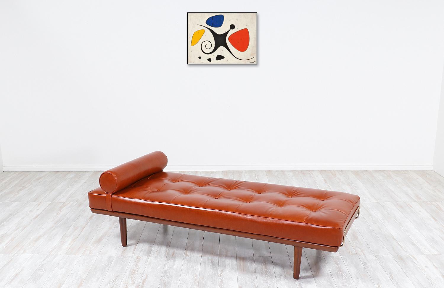 One of the most luxurious and comfortable daybeds from Denmark is this iconic model GE19 designed by architect Hans J. Wegner in collaboration with the famous workshop of GETAMA in 1956. It features an expertly crafted Italian cognac leather