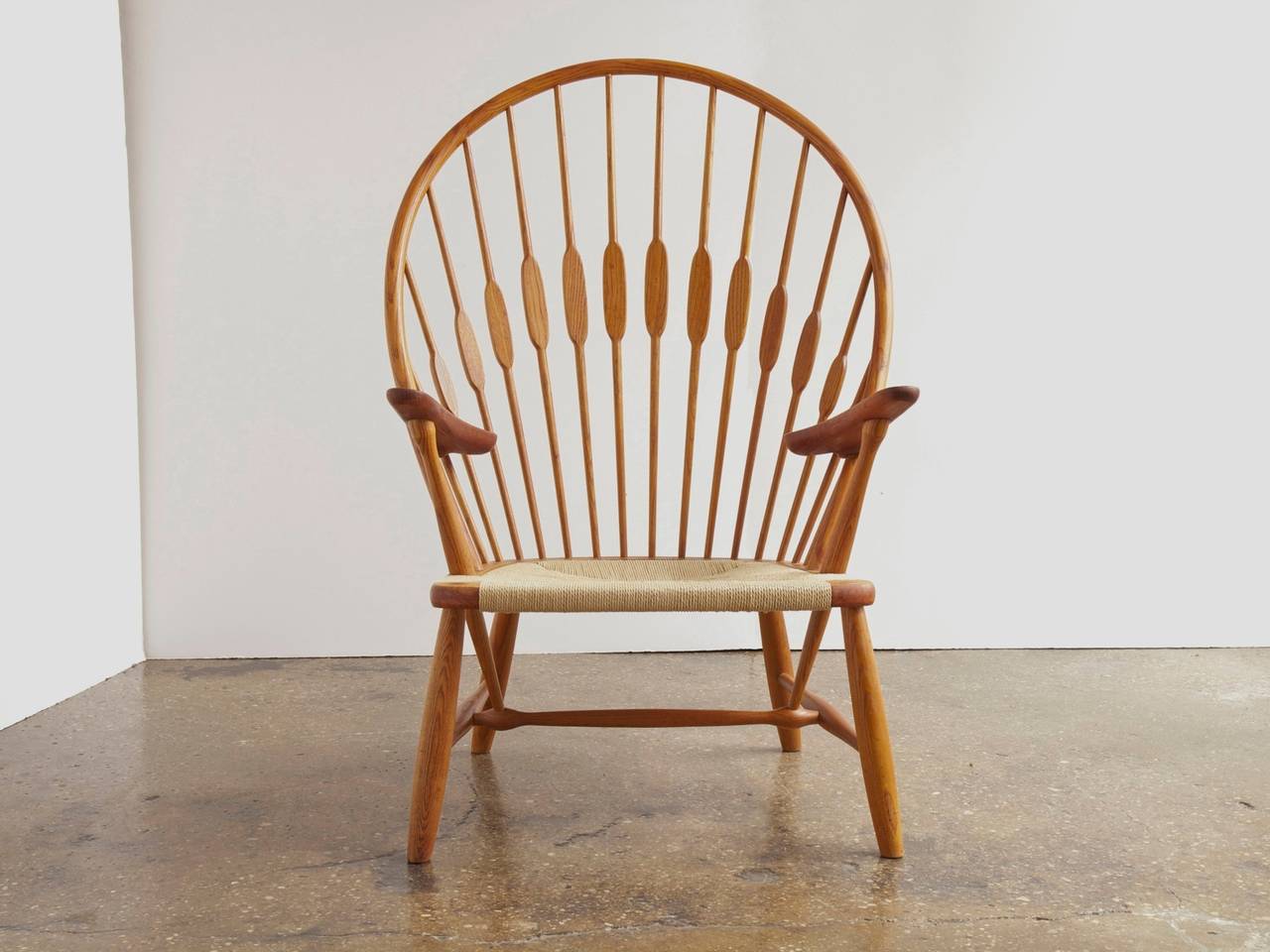 Hans J. Wegner's iconic take on the windsor chair, designed in 1947 and produced by Johannes Hansen. A wonderful example for the Danish modern collector. The chair is in excellent restored condition and has a new woven paper cord seat. Stamped on