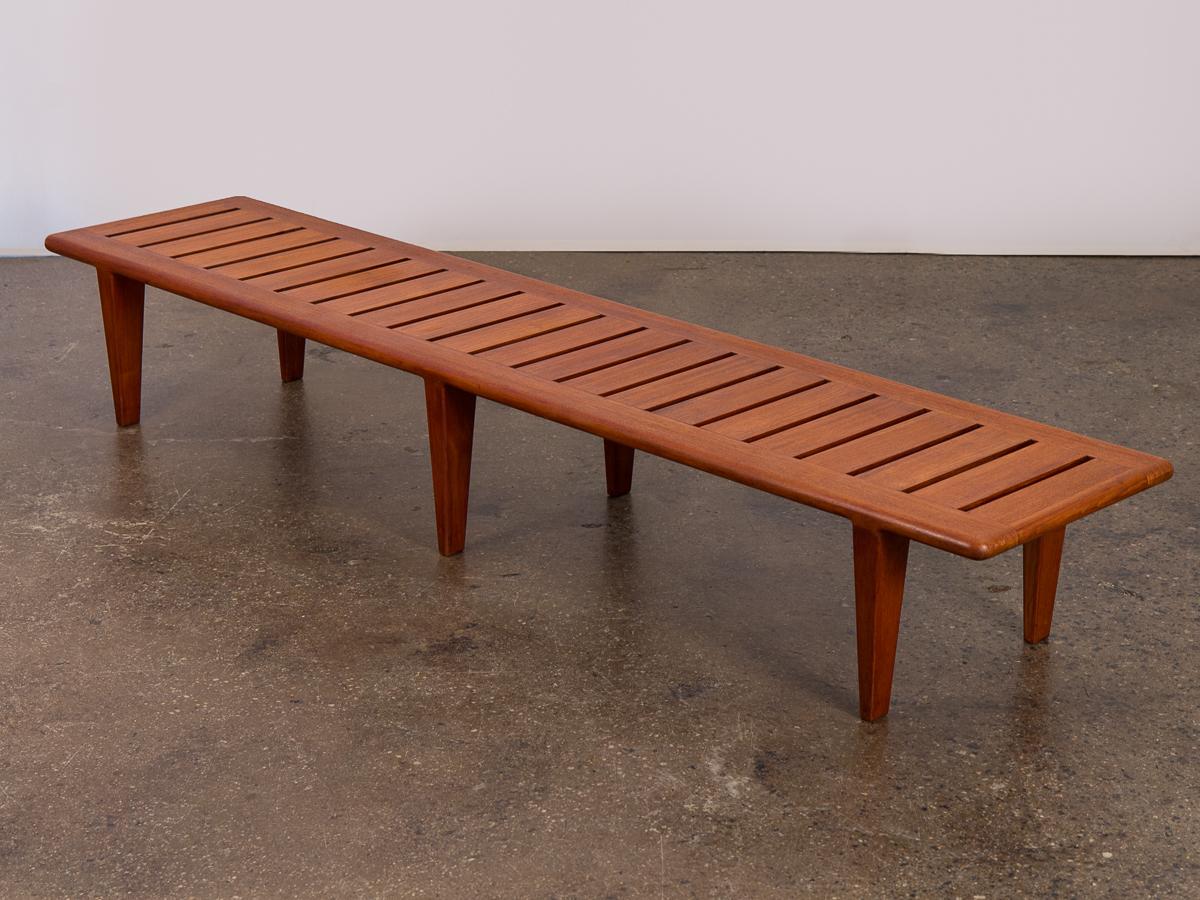 Hans J. Wegner teak slat bench, model JH-574 for Johannes Hansen. The hand of the cabinetmaker echoes within this most simple design. This strong, robust six-legged bench boasts a clean, minimalist personality. Teak selection is choice, with a