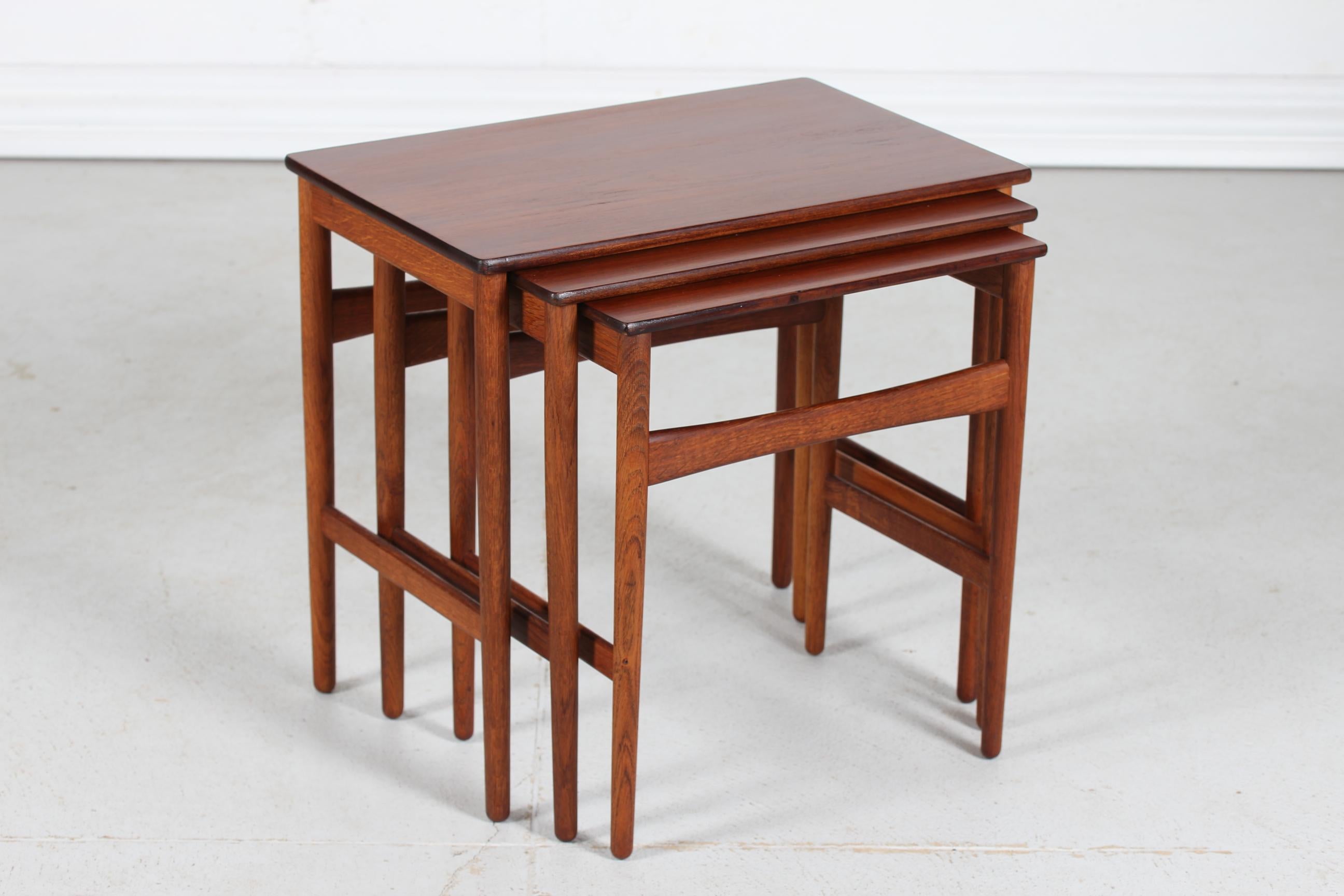 Danish vintage Hans Wegner (1914-2007) nesting tables model AT 40
The three tables are made of solid oak with table tops of solid teak

The nesting tables are manufactured by Andreas Tuck and remains in good vintage condition. 
Measures is of