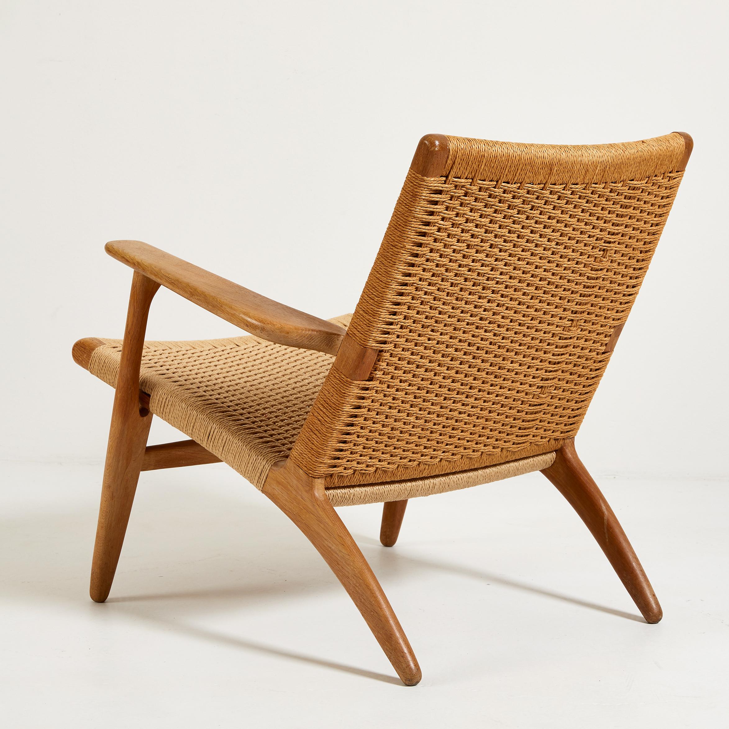 Hans Wegner for Carl Hansen & Son CH 25 lounge chair. Very good condition, marked on underside with Danish maker's label. Frame made in oiled oak. New papercord seat and back restored to exacting standards as the original. This is an original, early