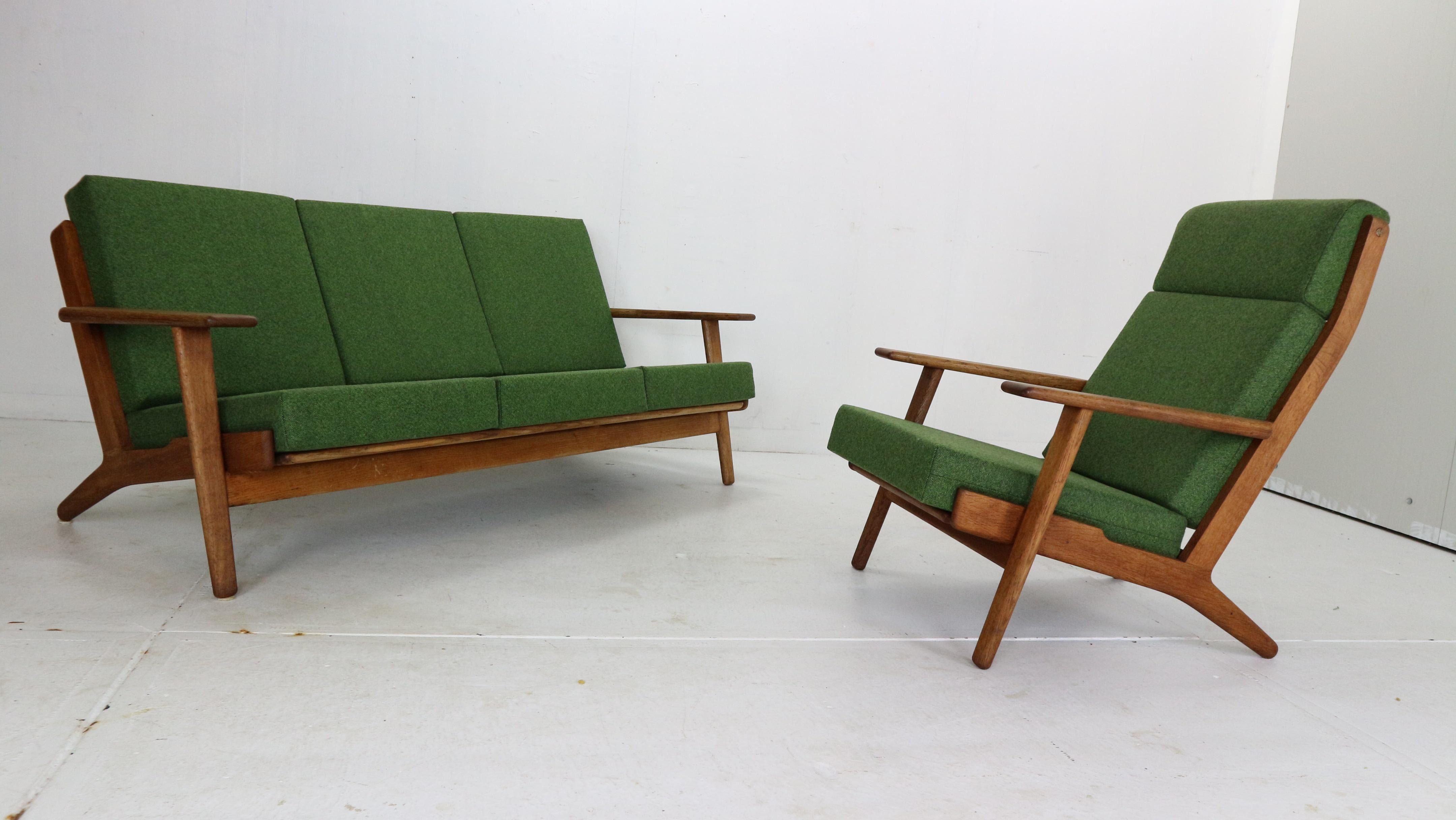 Scandinavian Modern living room set ( 3-seater sofa& lounge chair) both designed by Hans J. Wegner and manufactured by GETAMA in 1960's period, Denmark.

Solid oak sofa with elegant curving details and strong wide armrests, high backrests creates