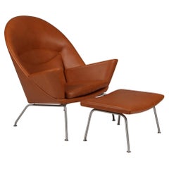 Hans J. Wegner Oculus Lounge Chair and ottoman in Full grain walnut leather