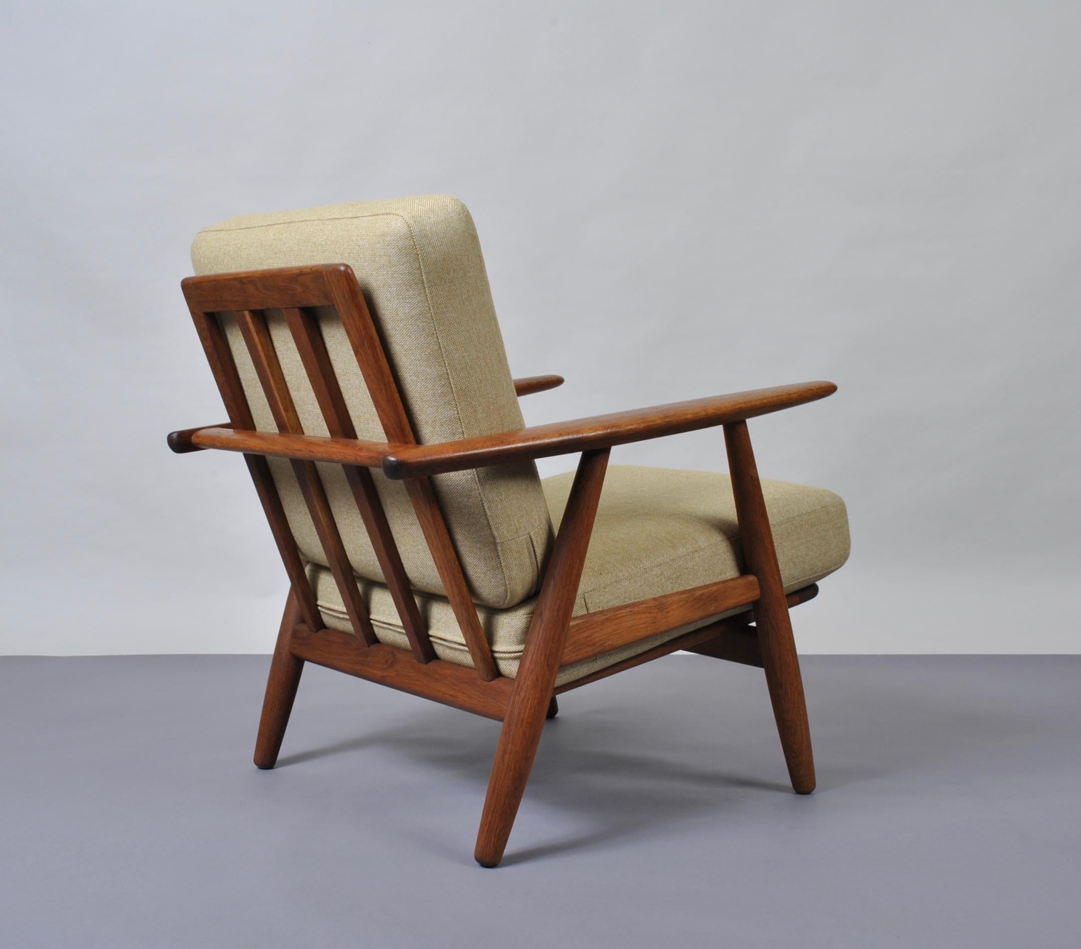 An original 1950s Hans J Wegner GE240 cigar chair, produced by GETAMA, Denmark.
Fumed oak frame with all new Camira wool flax weave upholstery. A coveted Danish classic by the master of chair design. Custom Reupholstery is available. Makers/design