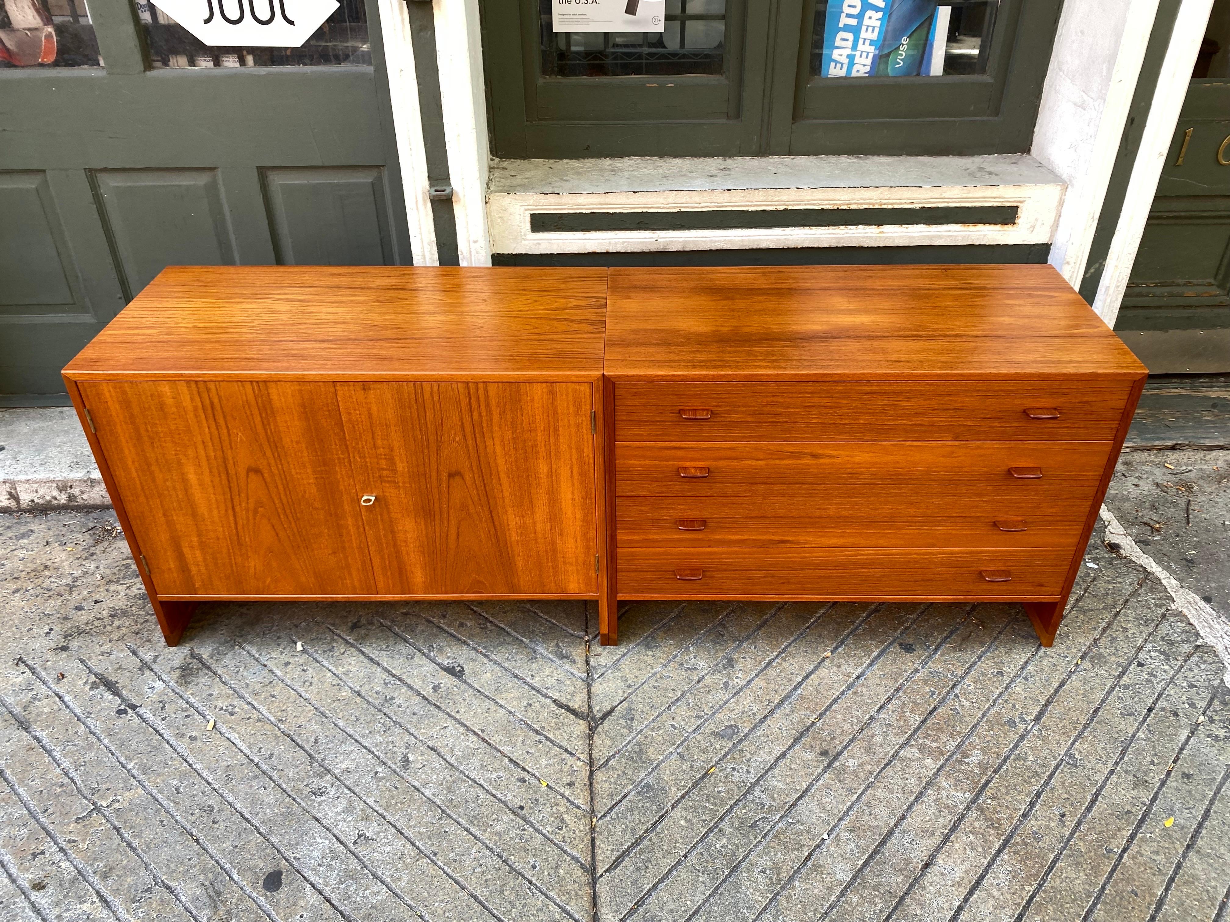 Beautiful Pair of Hans Wegner Designed Cabinets for Ry Mobler of Denmark.  Teak with Oak Runners and interior of Birch.  Beautifully crafted with subtle detailing throughout.  Can be used separately or they look great lined up as a Credenza.  Newly