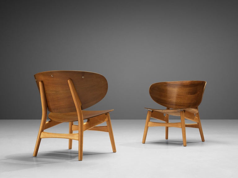 Hans J. Wegner for Fritz Hansen, pair of FH 1936 lounge chairs, walnut and beech, Denmark, design 1948, manufactured, circa 1950.

The FH 1936 lounge chair is one of the results of Wegner's efforts in designing furniture with plywood shells. Wegner