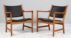 Hans J. Wegner pair of lounge chairs in oak and black leather, model CH52