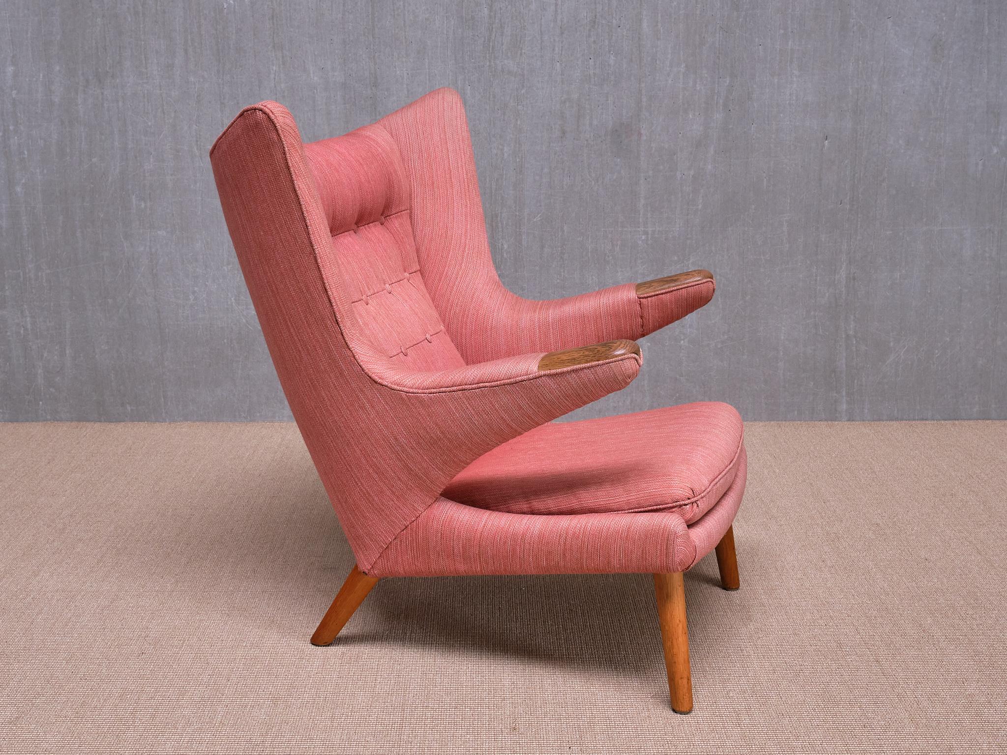 The iconic Papa Bear armchair was designed by Hans J. Wegner in 1951. This armchair on offer here was produced in 1963 by A.P. Stolen, the first and original manufacturer of the AP-19 model, better known as the Papa Bear chair. 
The chair is marked