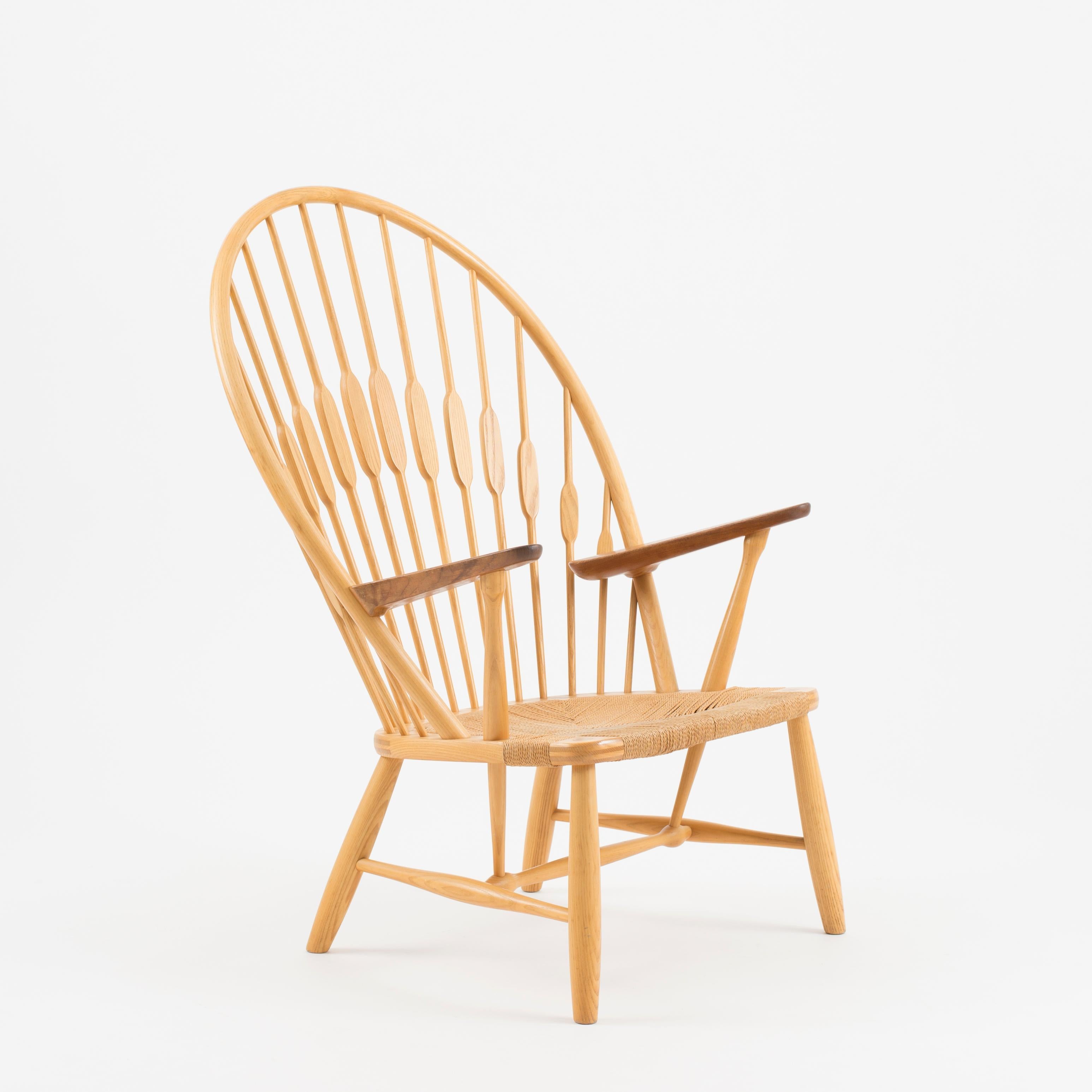 Hans J. Wegner “Peacock Chair”. An ashwood easy chair with teak armrests and woven papercord seat. Model JH 550. Executed and stamped by cabinetmaker Johannes Hansen.