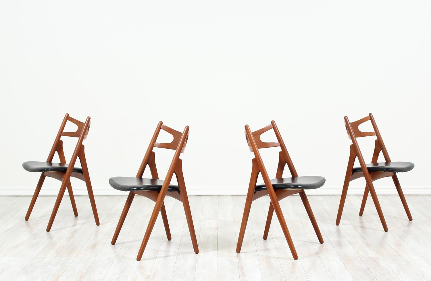 Set of four iconic “Sawbuck” CH-29 dining chairs designed by Hans J. Wegner for Carl Hansen & Søn in Denmark in 1952. This chair is defined by its A-shaped frame which can be seen from the profile view. This set is sturdily but simply constructed in