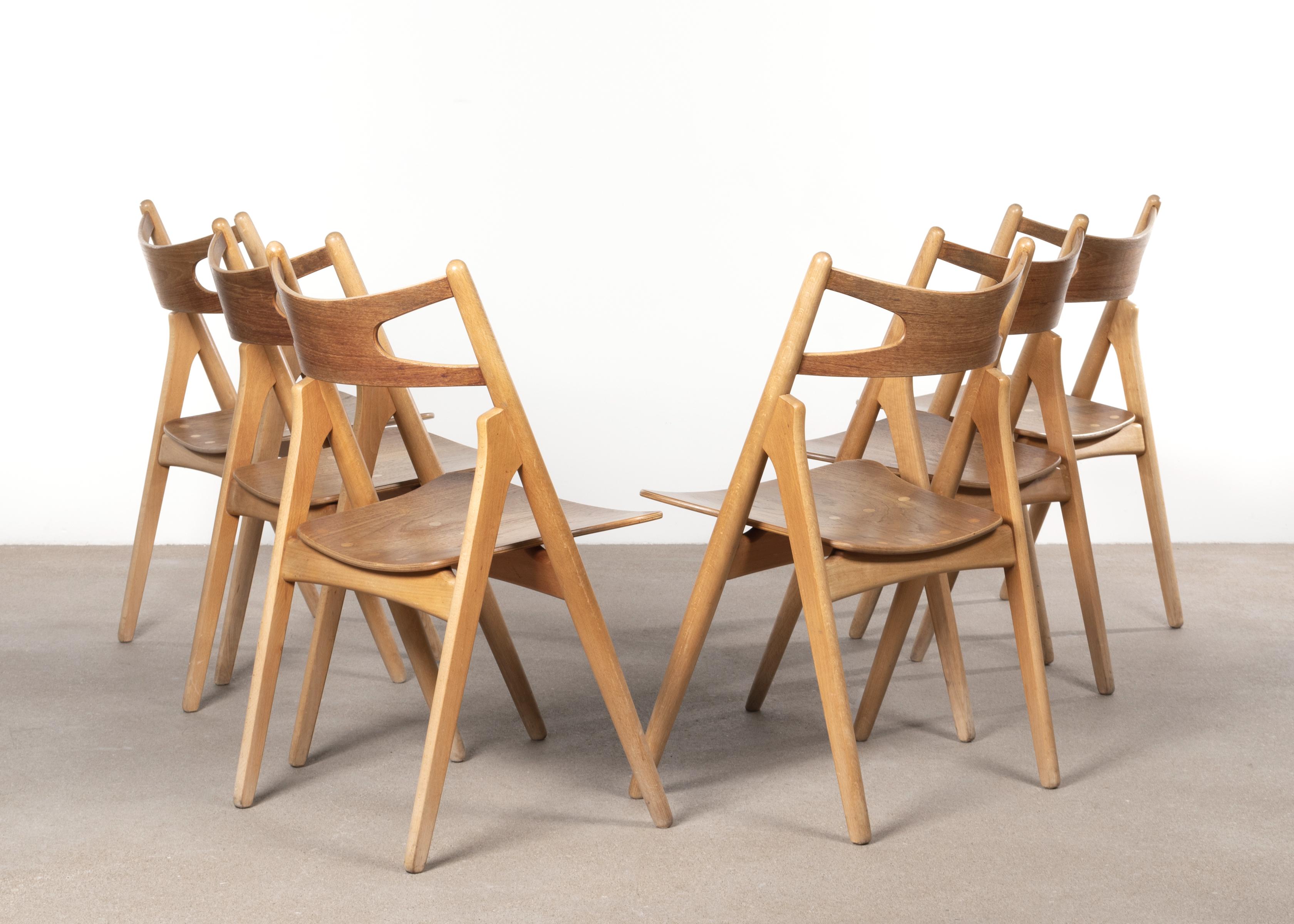 Hans Wegner sawbuck chairs model CH 29 for Carl Hansen. Beechwood frames and plywood teak seats / backrests with strong wood grain all in good untouched original condition. Available as set of 6 chairs with matching table if desired. Signed with