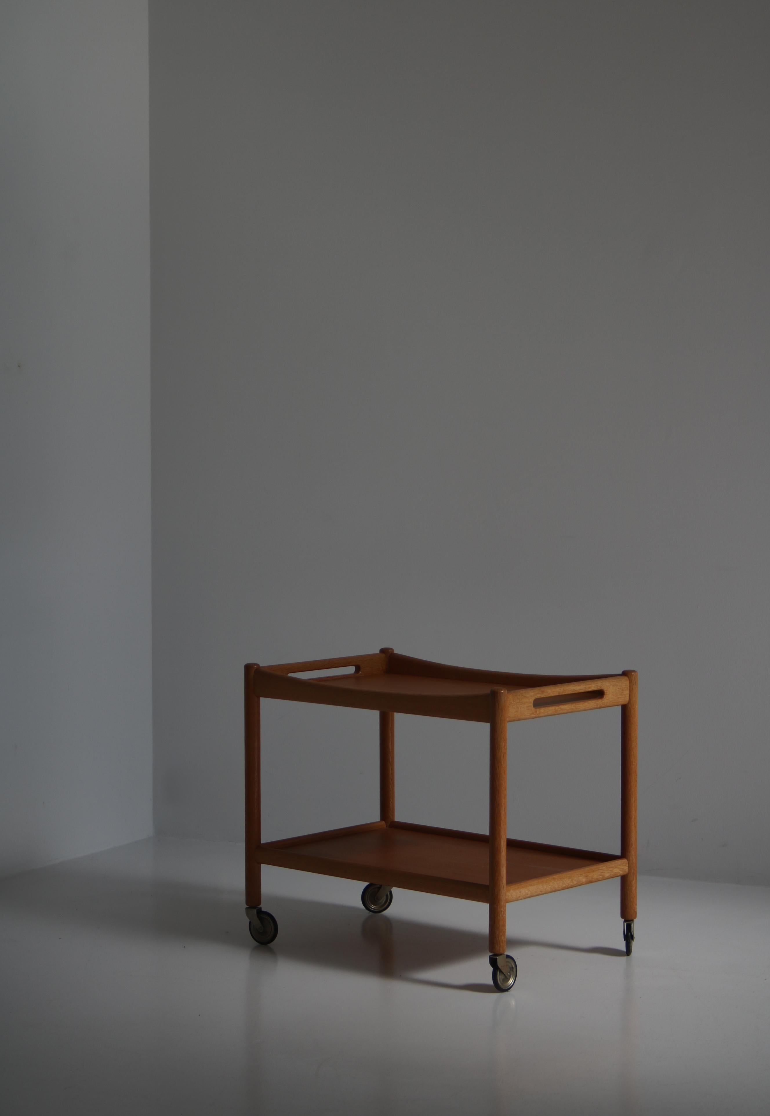 Wonderful serving cart from the 1960s by Hans J. Wegner, Denmark. Made at cabinetmaker Andreas Tucks workshop in Odense. The table is made from solid oak and iron castors. All parts are original and the table is in great working condition. It glides
