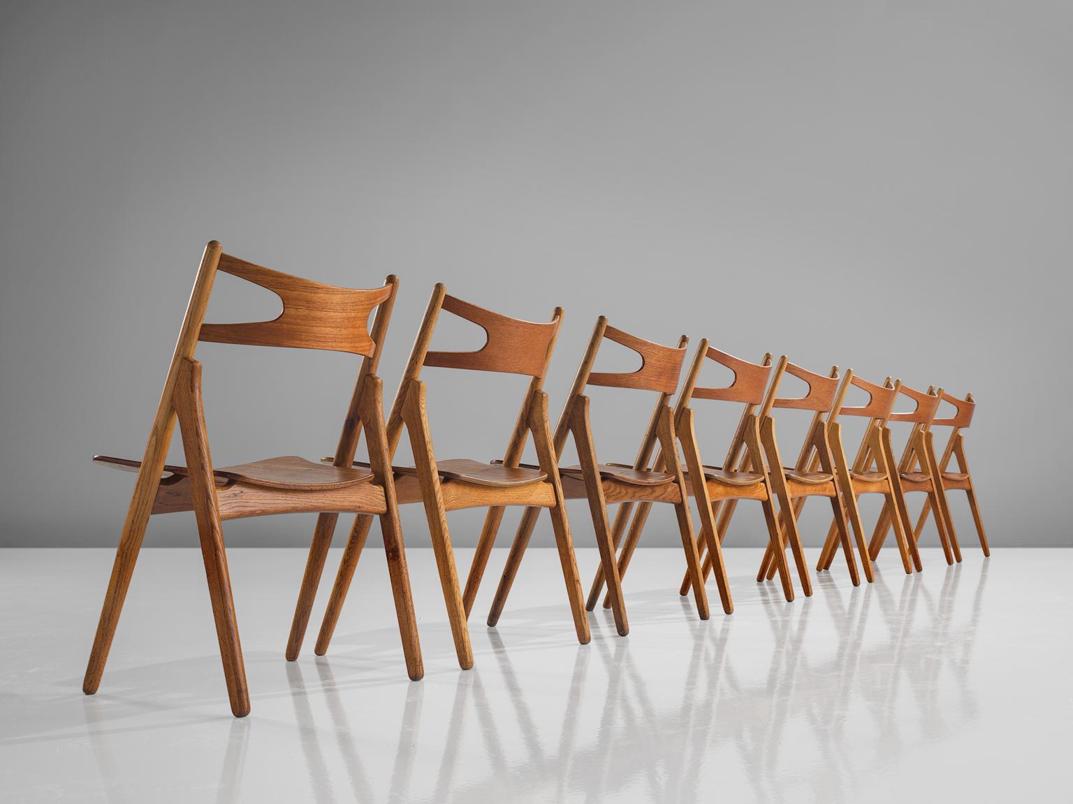 Hans J. Wegner for Carl Hansen & Søn, set of eight 'Sawbuck' CH29 chairs, oak, teak, Denmark, 1952.

This set of eight chairs is designed by Hans J. Wegner for Carl Hansen. This chair holds a very strong construction even though it has a simplistic