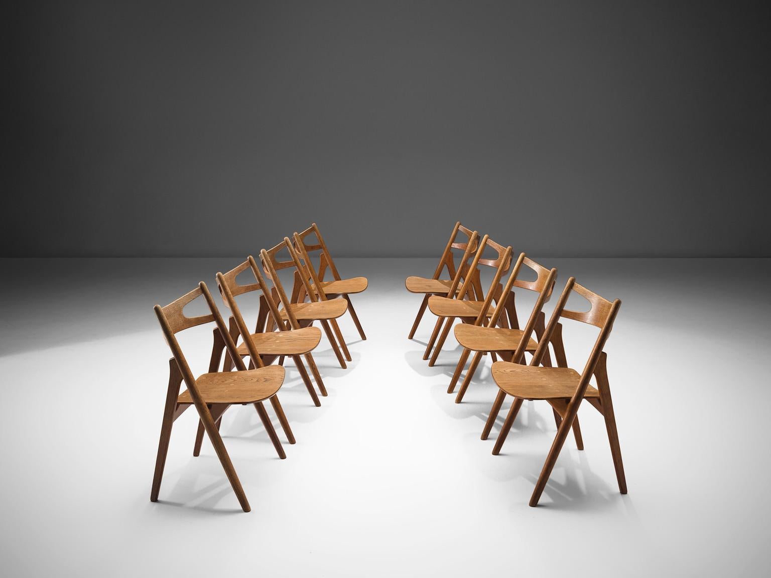 Hans J. Wegner for Carl Hansen & Søn, set of eight 'Sawbuck' CH29 chairs, oak, teak, Denmark, 1952.

This set of eight chairs is designed by Hans J. Wegner for Carl Hansen. This chair holds a very strong construction even though it has a simplistic