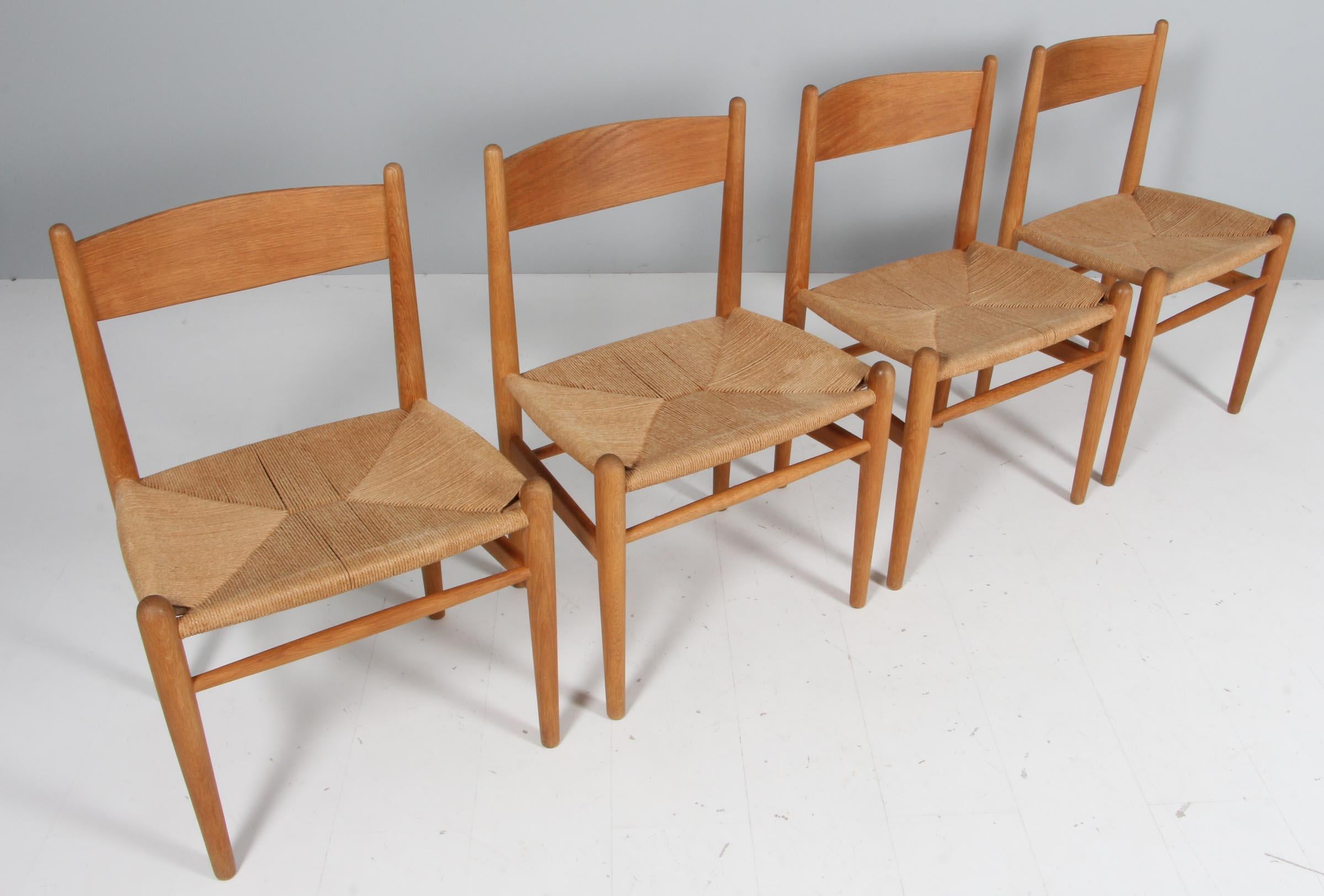 Hans J. Wegner set of four dining chairs in solid soap treated oak, original papercord seat. 

Model CH36, made by Carl Hansen.