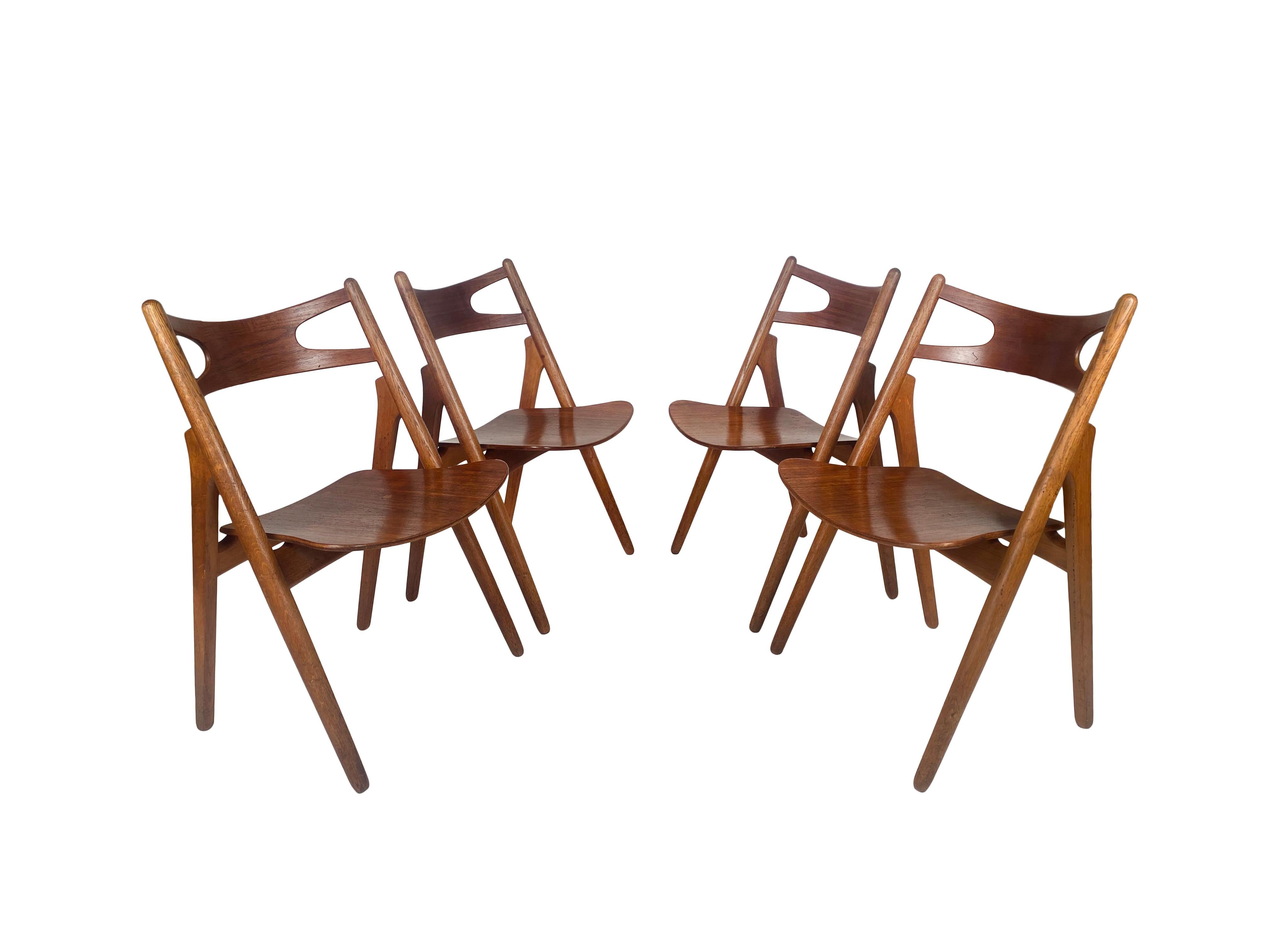 Lovely set of four sawbuck dining chairs, model CH-29, designed by Hans J. Wegner, manufactured for Carl Hansen & Søn in Denmark, 1950s.

These beautiful pieces are all original, completely wooden editions made of the great quality oakwood with a