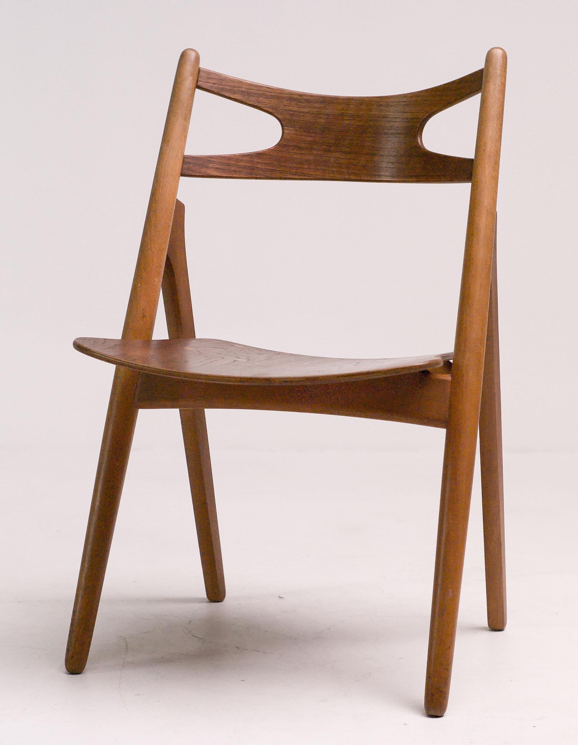 Hans J. Wegner for Carl Hansen & Søn, set of four 'Sawbuck' CH29 chairs, teak, Denmark, 1952. 
This set of four chairs is designed by Hans J. Wegner for Carl Hansen. 
This is the most desirable version with visible seat construction.
The table is