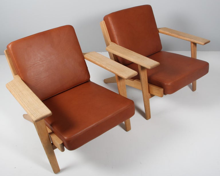 Hans J. Wegner set of lounge chairs made of solid soap treated oak.

New upholstered with tan aniline leather.

Model 290, made by GETAMA.

