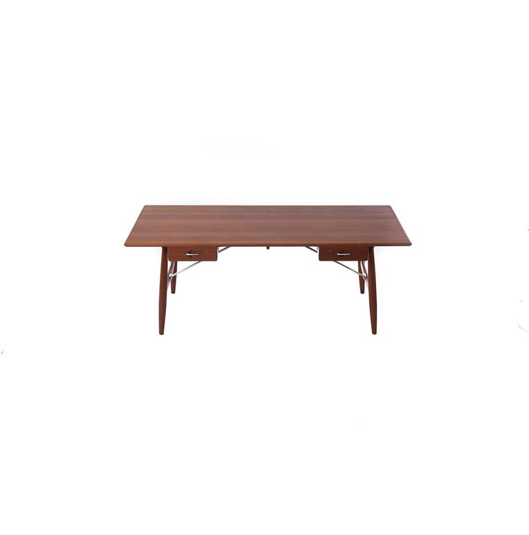 This is a beautiful and pristine solid teak desk by Hans J. Wegner, made by Johannes Hansen in the mid-1950s. Stainless hardware, all teak. Condition is excellent.

Professional, skilled furniture restoration is an integral part of what we do