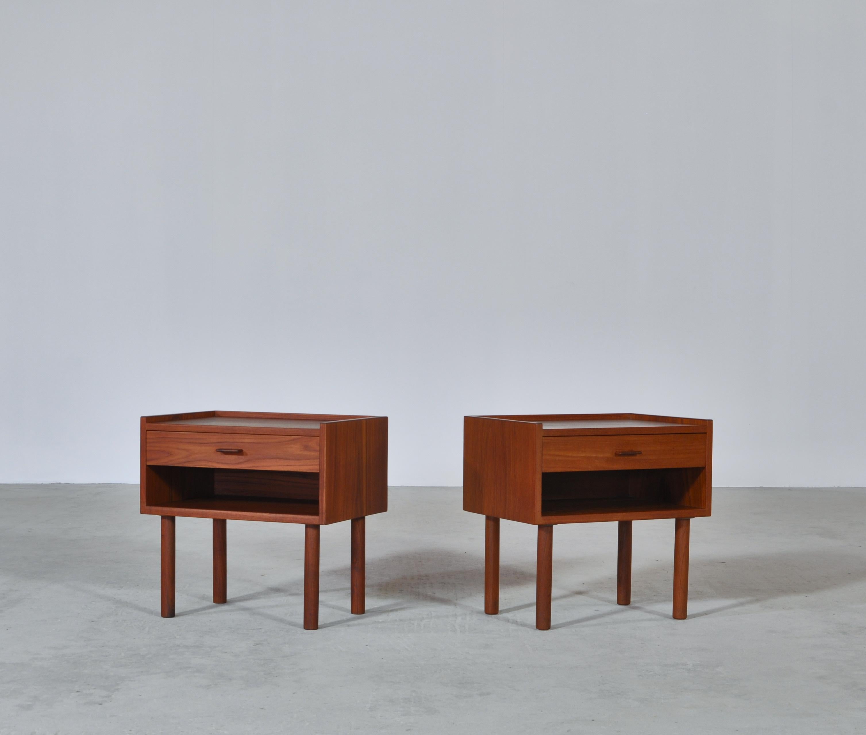 A pair of Danish modern bedside tables from the 1960s by Hans J. Wegner. Typical of Wegner's designs from this period is the minimalistic approach to design and the subtle details. Each table features solid conical teak legs and a drawer with a