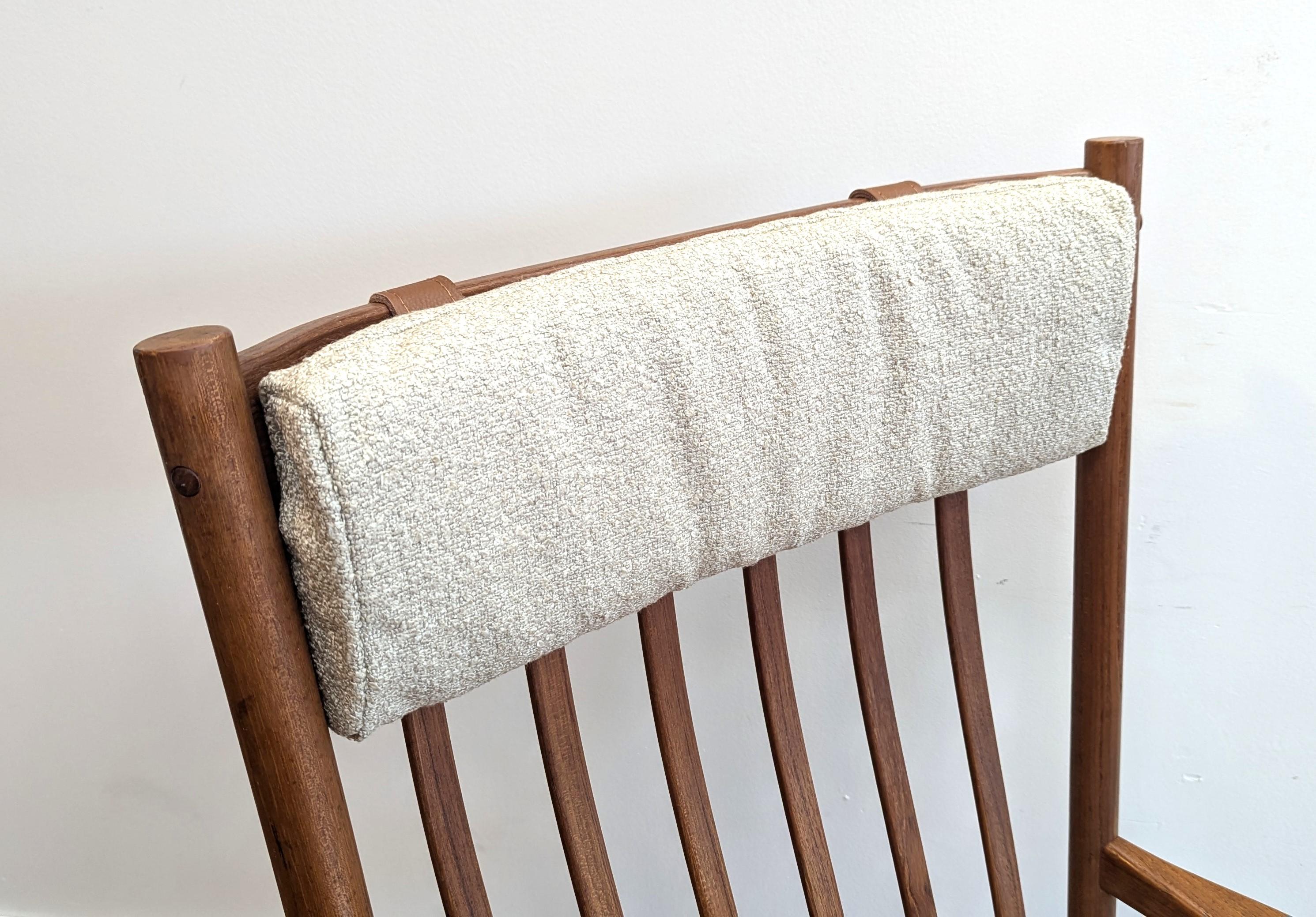 Hans J. Wegner Teak Rocking Chair for Tarm Stole.  Really nice rocking chair by Hans Wegner of solid teak with new Boucle covering.  Chair maintains it's original seat with mesh and label remnant, also the original brass knobs for the pillow.  New