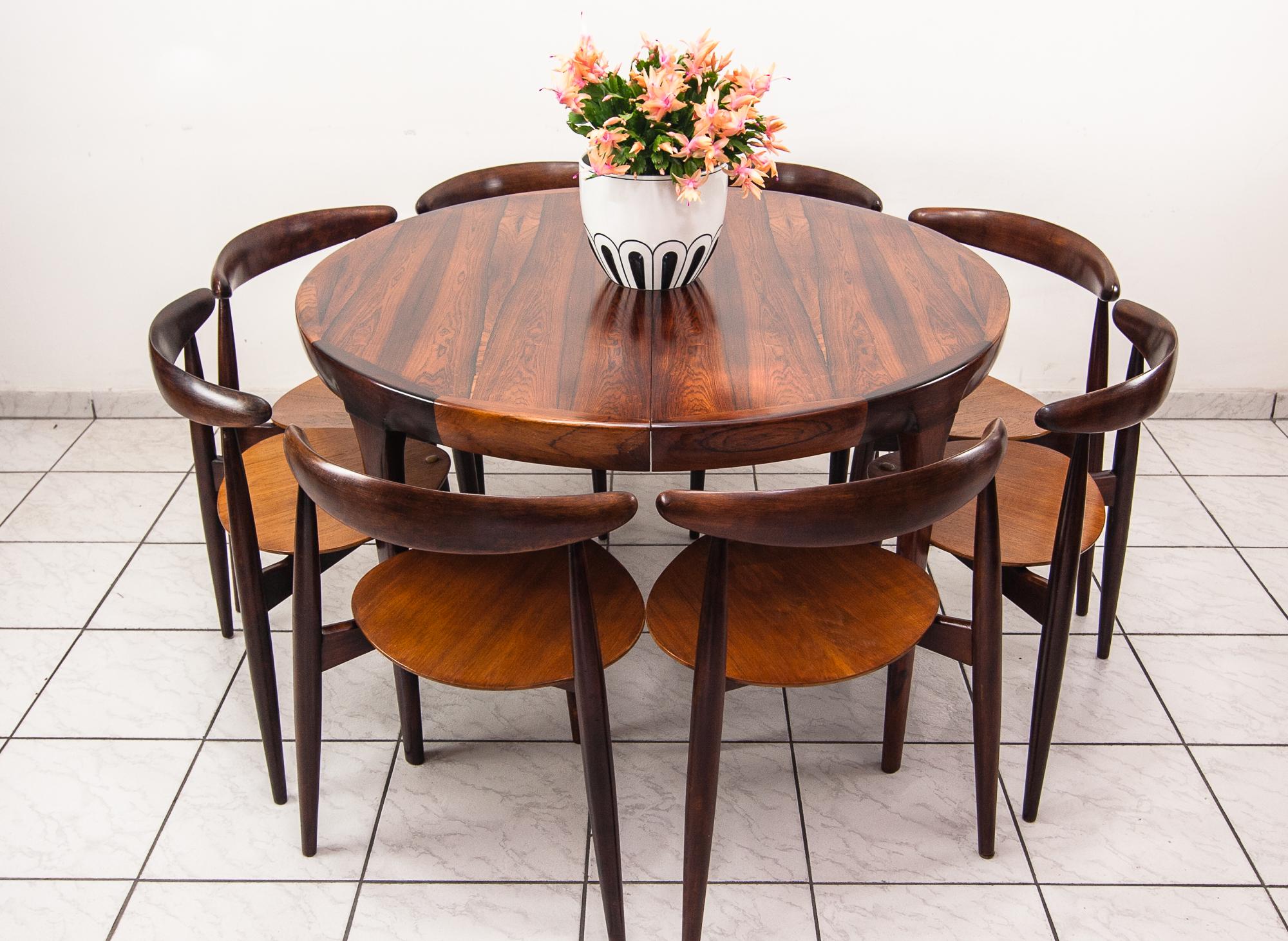 Hans J Wegner ‘The Heart' dining suite made in Denmark by Fritz Hansen circa 1950,
with eight ‘heart’ chairs Model FH4103 made from teak and beech frames, the chairs are all stackable,
the table is made from palisander wood, The table is not by Hans