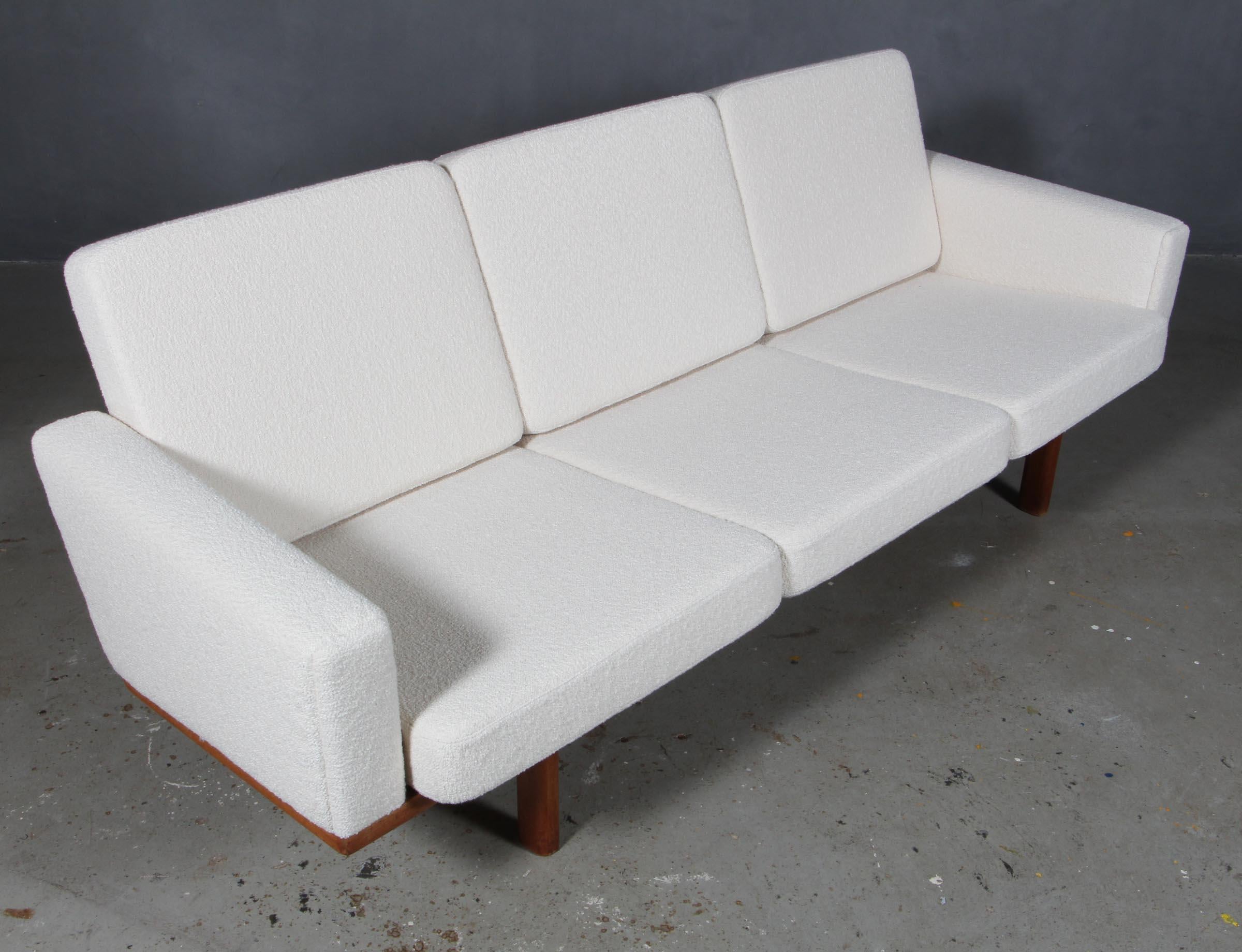 Hans J. Wegner three-seat sofa new upholstered with Boucle.

Frame in solid oak.

Model 236/3, produced by GETAMA.