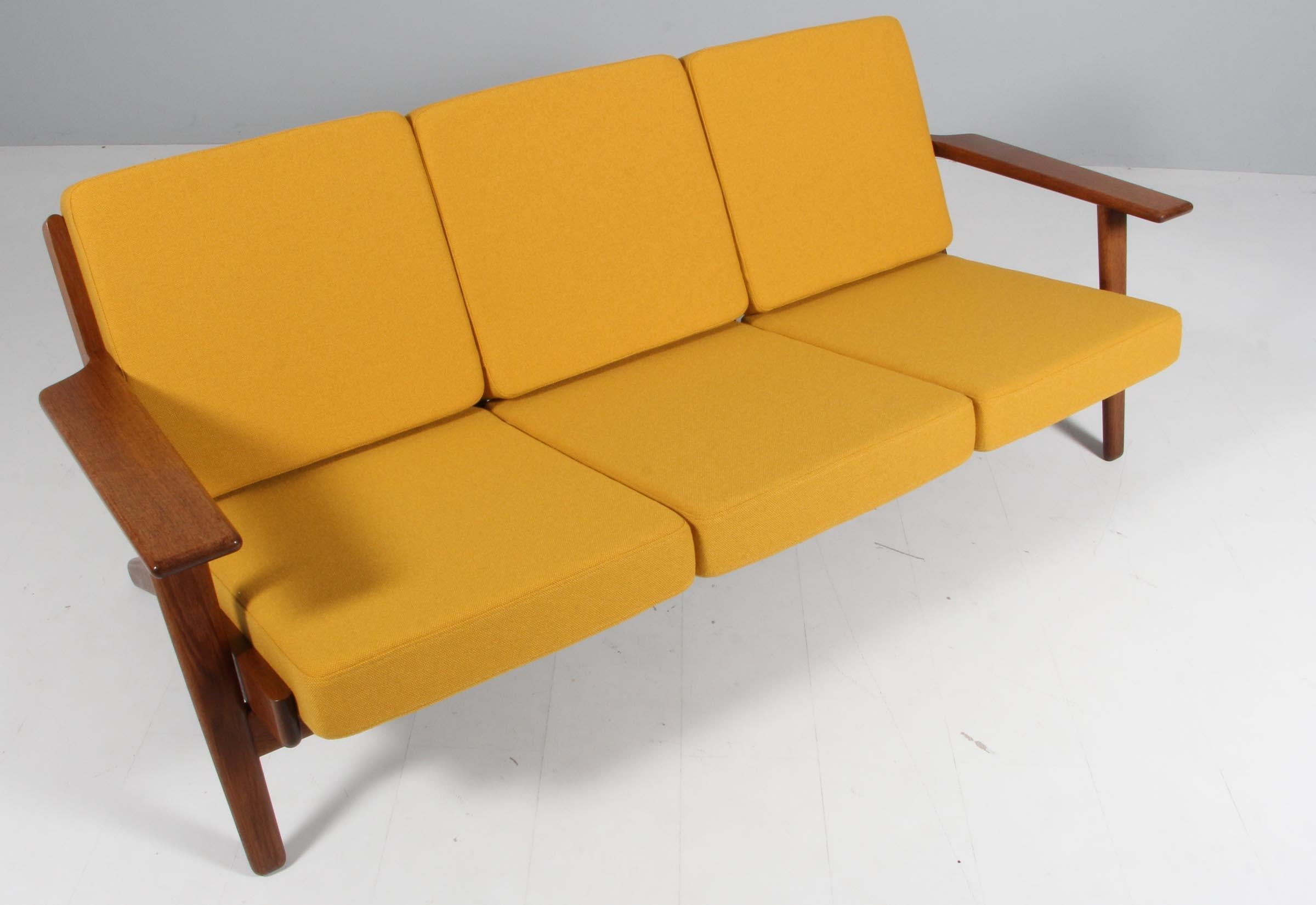 Hans J. Wegner three-seat sofa made of smoked oak.

New upholstered cushions with yellow fabric.

Model 290, made by GETAMA.

