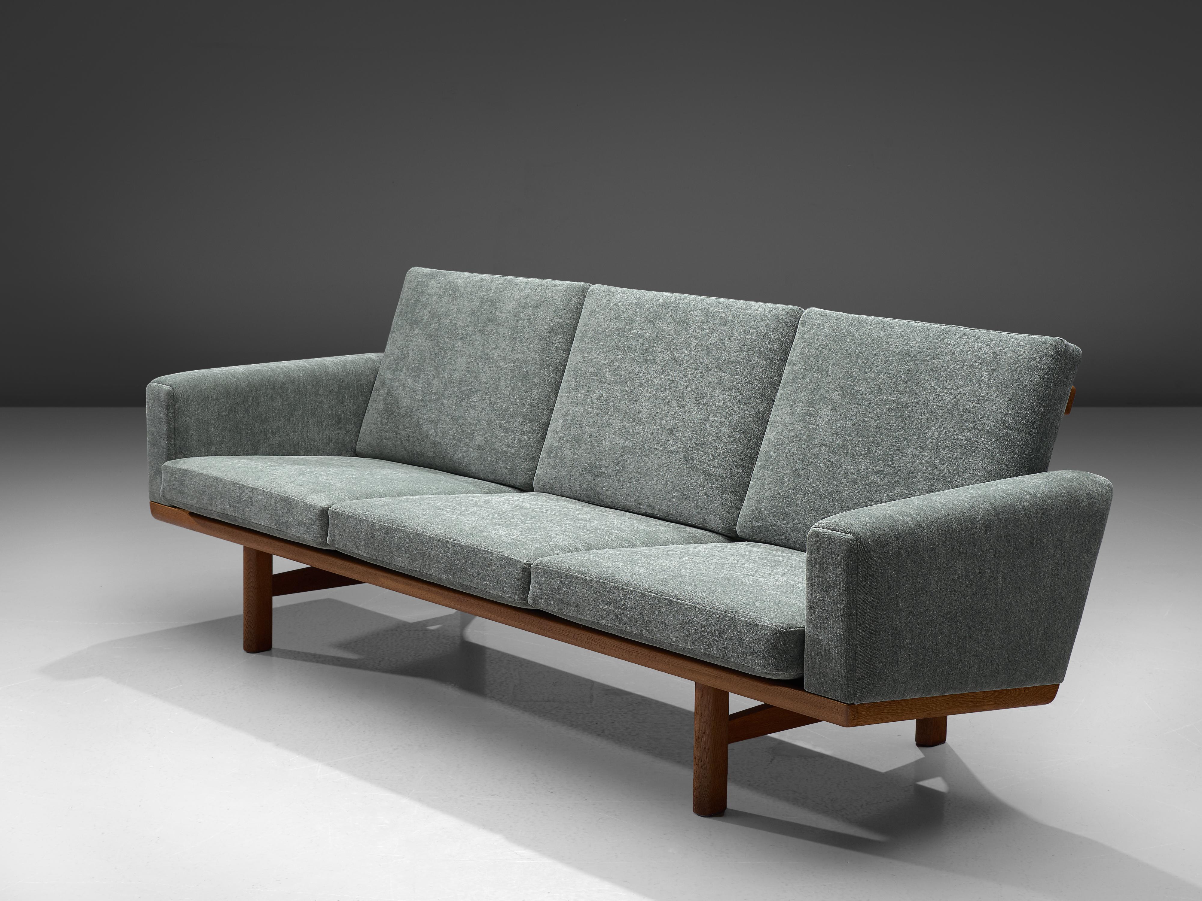 Hans J. Wegner, three-seat sofa model GE-236/3, fabric and oak, Denmark, 1950s

Beautiful sofa by Danish designer Hans J. Wegner. The sofa has been reupholstered in our in-house atelier with a high quality Dedar fabric. This sofa has a solid oak