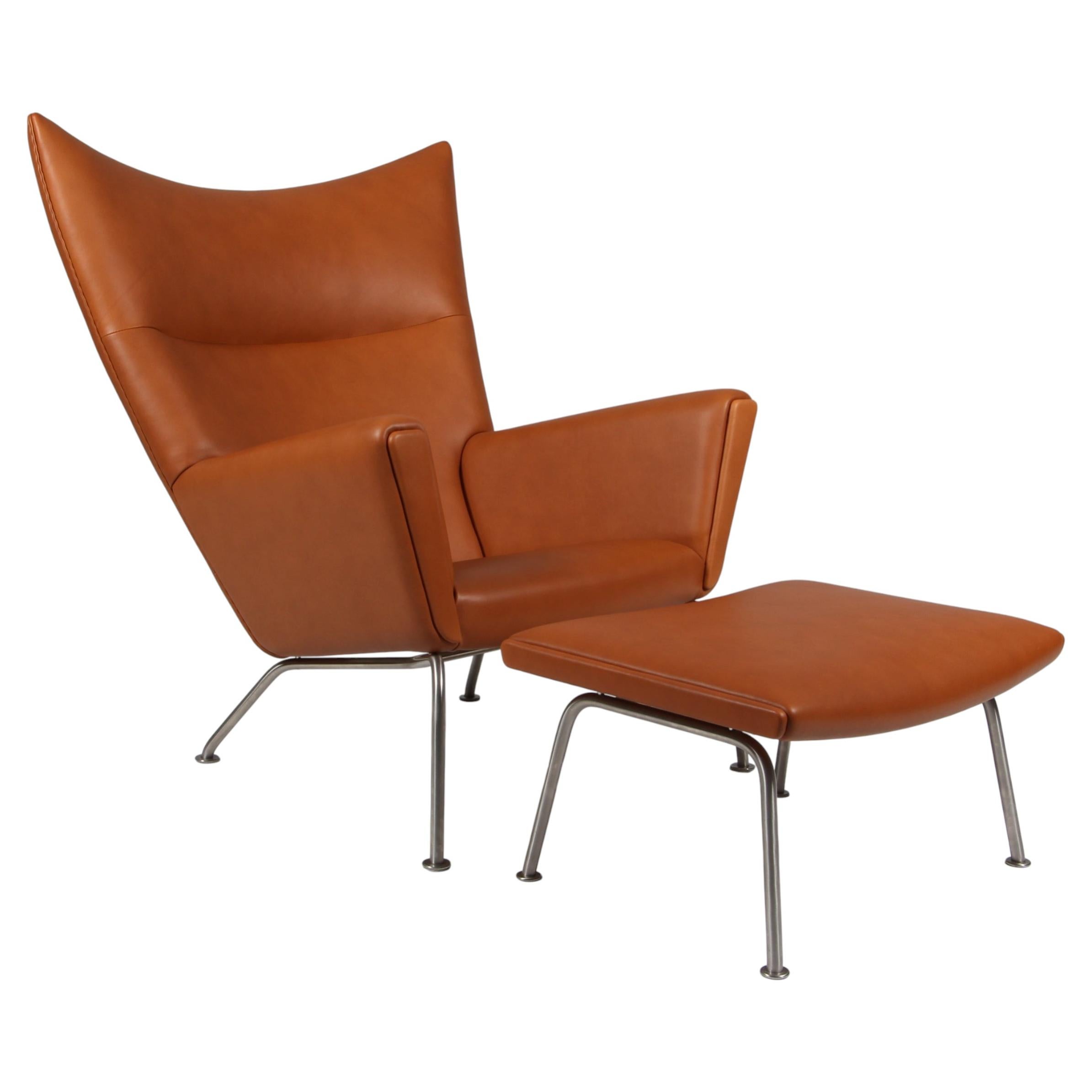 Hans J. Wegner wing chair and ottoman in full grain leather, model CH445 For Sale