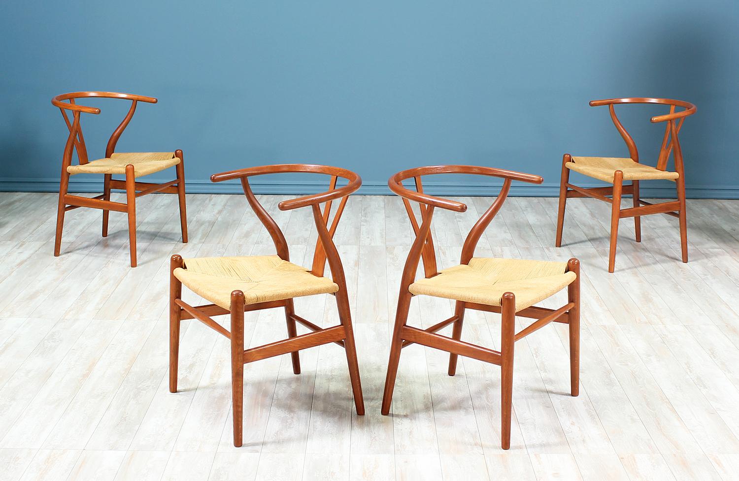Set of four CH-24 dining chairs designed by Hans J. Wegner for Carl Hansen & Søn in Denmark in 1950. Often referred to as the ‘Wishbone’ chair or the ‘Y’ chair, this iconic design with Chinese influences, features an oak wood frame and the original