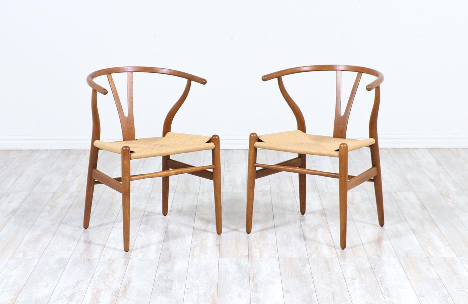 Pair of CH-24 arm chairs designed by Hans J. Wegner for Carl Hansen & Søn in Denmark in 1950. Often referred to as the ‘Wishbone’ chair or the ‘Y’ chair, this iconic design with Chinese influences, features an oak wood frame and the new rush cord on