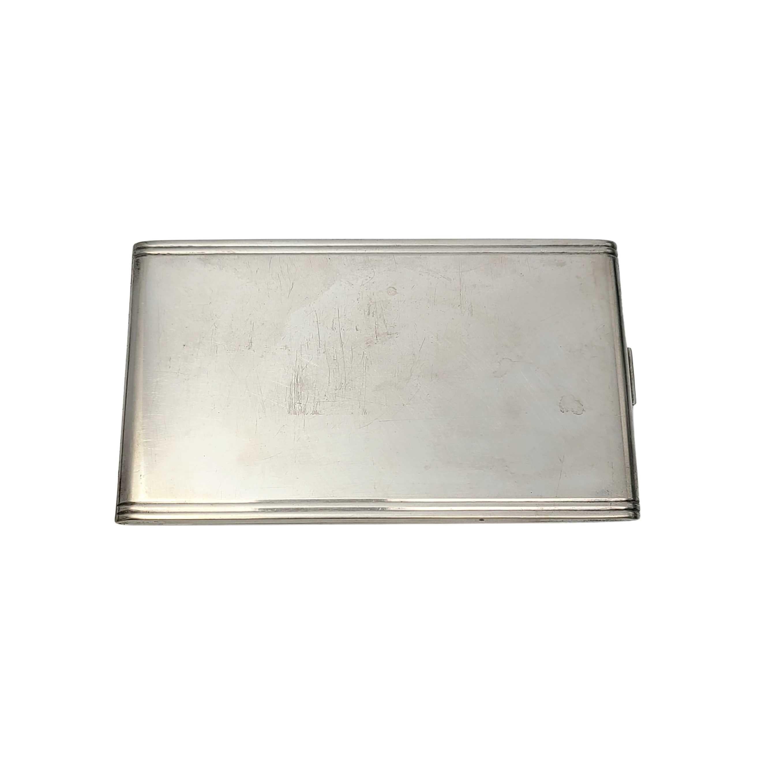 Vintage .826 silver cigarette case by Hans Jensen of Denmark.

This piece features a smooth polished finish with banded edges. Push button mechanism to open. No monogram.

Measures approximate 3 1/8